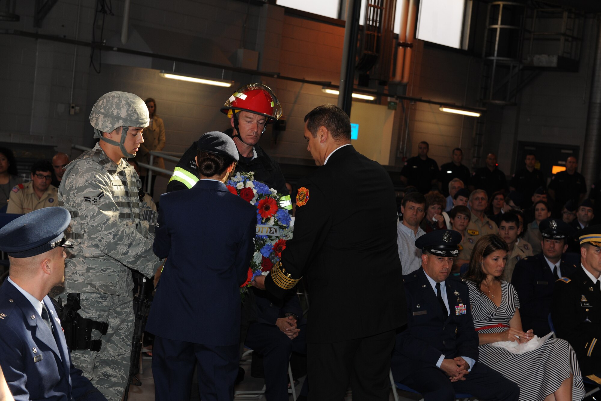 The emergency serivces detail lays a wreath in honor of those killed in the attacks on 9/11. Two members of the detail were in service dress, representing garrison duty and the responsibility to protect their countrymen and women at home, while the other two members were in full combat uniform representing wartime duty and the responsibility to protect not only their homelands, but also the homelands of those incapable of defending themselves. (U.S. Air Force photo by Tech. Sgt. John Barton)