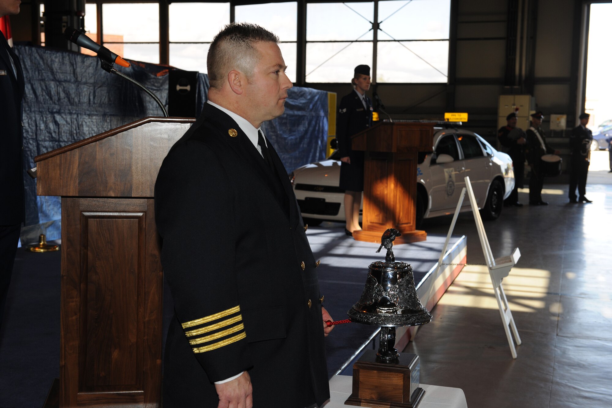 Assistant Fire Chief Eric Pietrylo, 423rd Civil Engineer Squadron, strikes the four fives at the start of a 9/11 Ceremony at RAF Alconbury Sept. 11. The four fives is the signal transmitted from headquarters to firehouses to signal that a firefighter died in the line of duty. (U.S. Air Force photo by Tech. Sgt. John Barton)