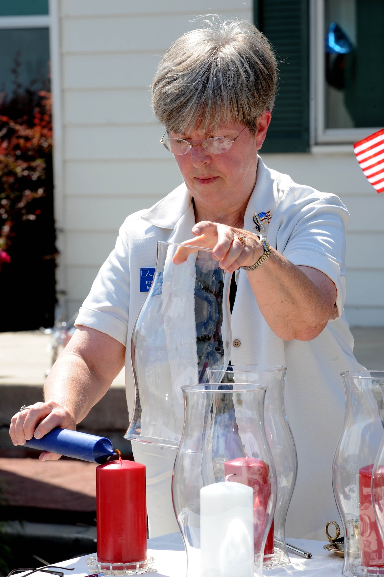 Junelle Mongno, National Society of the Daughters of the American Revolution Maj. Jacob Gray Chapter chapter regent, lights a memorial candle during the Sept. 11 National Day of Service and Remembrance at the Jacksonville Museum of Military History, on Sept. 11. The candles lit during the remembrance pay tribute to those who lost their lives during the Sept. 11, 2001 attacks. (U.S. Air Force photo by Staff Sgt. Jim Araos)