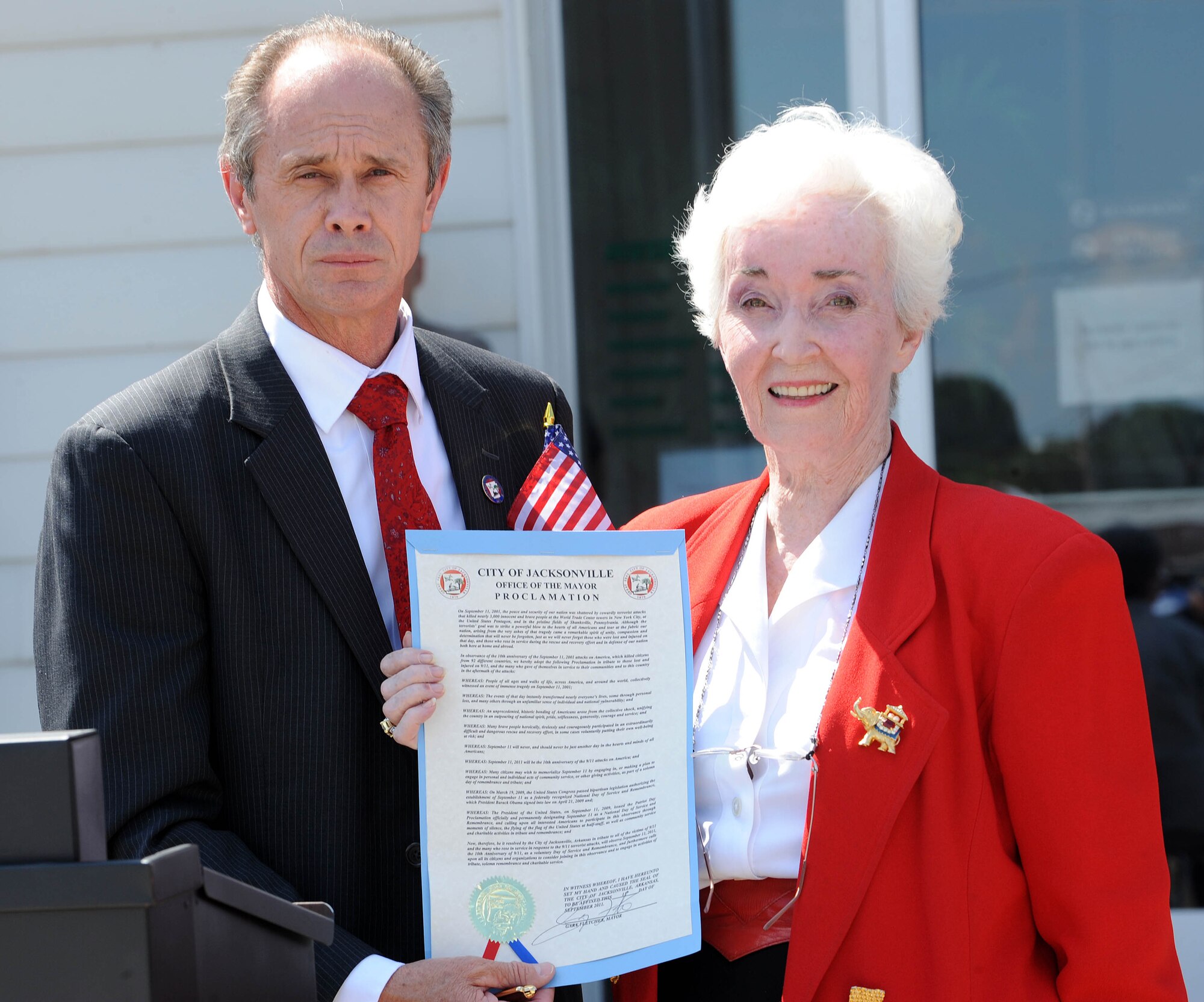 Major Gary Fletcher,  Jacksonville, and Ms. Joan Zumwalt, Pathfinder, Inc. volunteer, present a Proclamation during the Sept. 11 National Day of Service and Remembrance at the Jacksonville Museum of Military History, on Sept. 11. The proclamation is a tribute to those who were lost and injured on Sept. 11, 2001, and the many who gave of themselves in the service of their country in the aftermath of the attacks. (U.S. Air Force photo by Staff Sgt. Jim Araos)