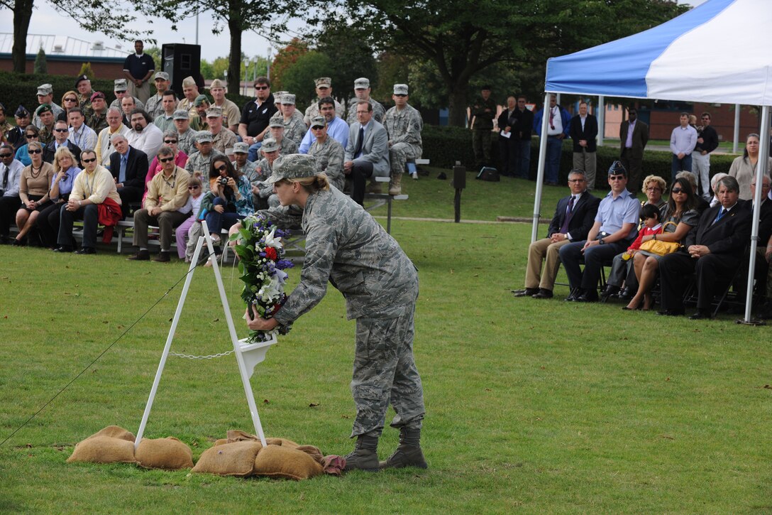 Personnel from the 501st Combat Support Wing, U.S. European Command Joint Analysis Center, U.S. Africa Command J2-Molesworth and NATO's Intelligence Fusion Centre watch as Col. Michele Cook, U.S. Africa Command J2-M commander, lays a wreath during a 9/11 Ceremony at RAF Molesworth Sept. 9. (U.S. Air Force photo by Tech. Sgt. John Barton)