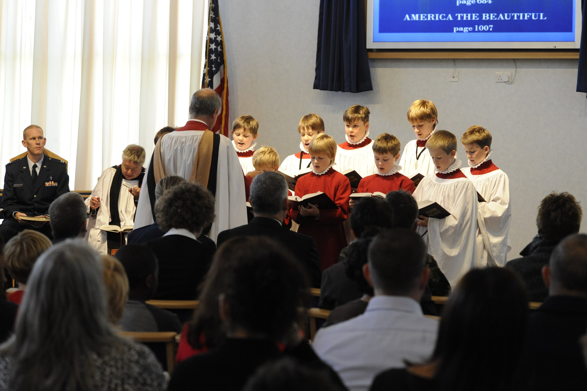 Choristers from the Ripon Cathedral choir school sing "America the Beautiful," during the 9/11 remembrance ceremony at the Menwith Hill Station chapel Sept. 12. The joint ceremony included a look-back video of events from that day, a small reflection from Chaplain (Capt.) Chad Bellamy, MHS Chaplian, and Canon Kieth Punshon, Ripon Cathedral, and songs performed by the choir. (U.S. Air Force photo by Tech. Sgt. Todd Wivell)