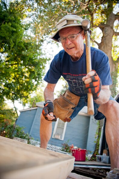 Dick Bates, construction crew leader, secures backing to a wall during day one of the 2nd Annual Valdosta-Lowndes County Habitat for Humanity Freedom Build in Valdosta, Ga., Sept. 10, 2011. The home has a completion date of Sept. 17. On that day, the Mabry family will receive keys to the home and can officially move in. (U.S. Air Force photo by Staff Sgt. Jamal D. Sutter/Released) 