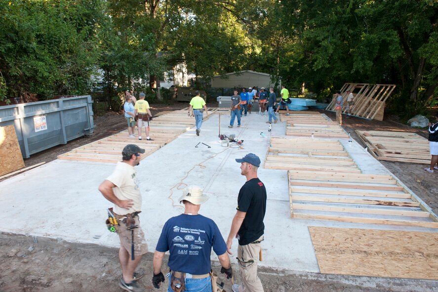 Volunteers from Moody Air Force Base, Ga., Valdosta State University and the Valdosta, Ga., community prepare to set and build walls during the first day of the 2nd Annual Valdosta-Lowndes County Habitat for Humanity Freedom Build in Valdosta Sept. 10, 2011. This year’s Freedom Build home is at 504 Magnolia Street and will be home to Tim and Miranda Mabry and their three children, Madeline, Lillian and Jacob. Tim’s mother, Carol Cooper will also stay in the home. (U.S. Air Force photo by Staff Sgt. Jamal D. Sutter/Released)