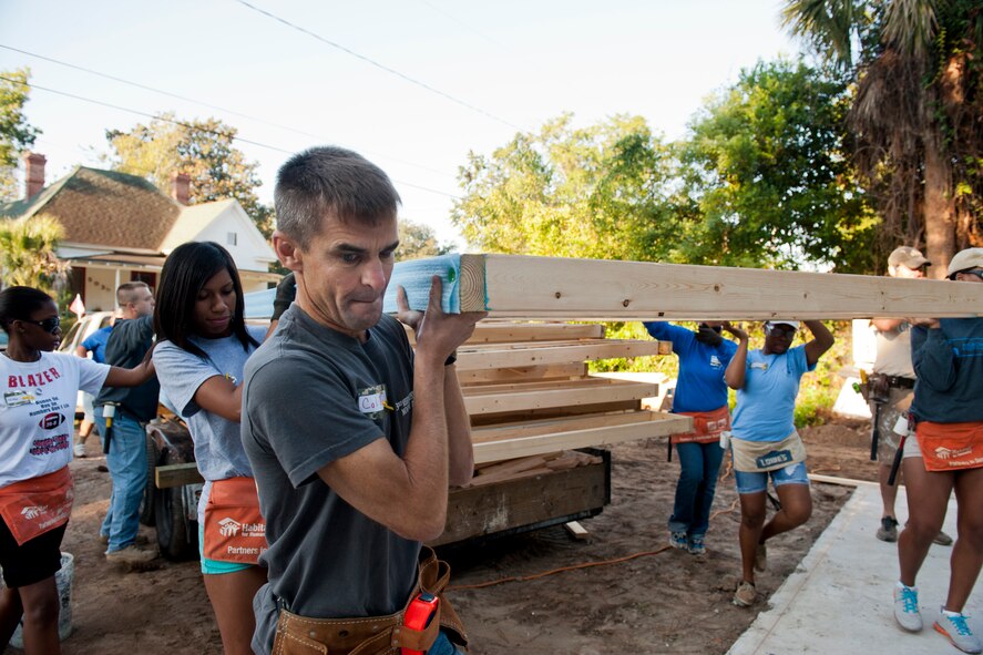 U.S. Air Force Col. Mark Ruse, 23rd Mission Support Group commander, helps carry a wall frame during day one of the 2nd Annual Valdosta-Lowndes County Habitat for Humanity Freedom Build in Valdosta, Ga., Sept. 10, 2011. The Freedom Build was established in memory of those who lost their lives during the events of 9/11. The annual program provides a safe and affordable home to a deserving family in the local community. (U.S. Air Force photo by Staff Sgt. Jamal D. Sutter/Released)