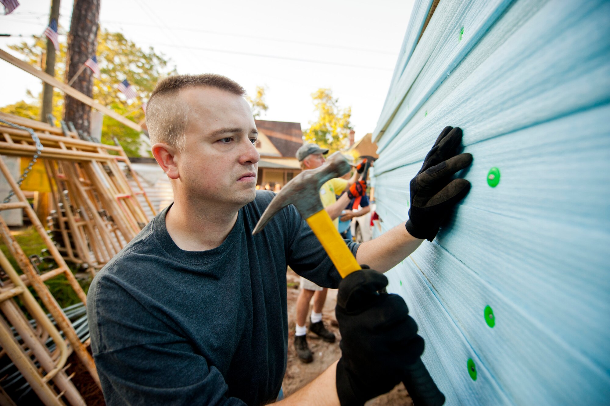 U.S. Air Force Master Sgt. Kyle Seevers, 23rd Wing plans and programs, secures nails into the insect barrier of a wall frame during day one of the 2nd Annual Valdosta-Lowndes County Habitat for Humanity Freedom Build in Valdosta, Ga., Sept. 10, 2011. The barrier seals the house’s floor to the cement, which helps keep insects from entering the house. The barrier also helps prevent unwanted ventilation, keeping electricity costs down for the gaining family. (U.S. Air Force photo by Staff Sgt. Jamal D. Sutter/Released)