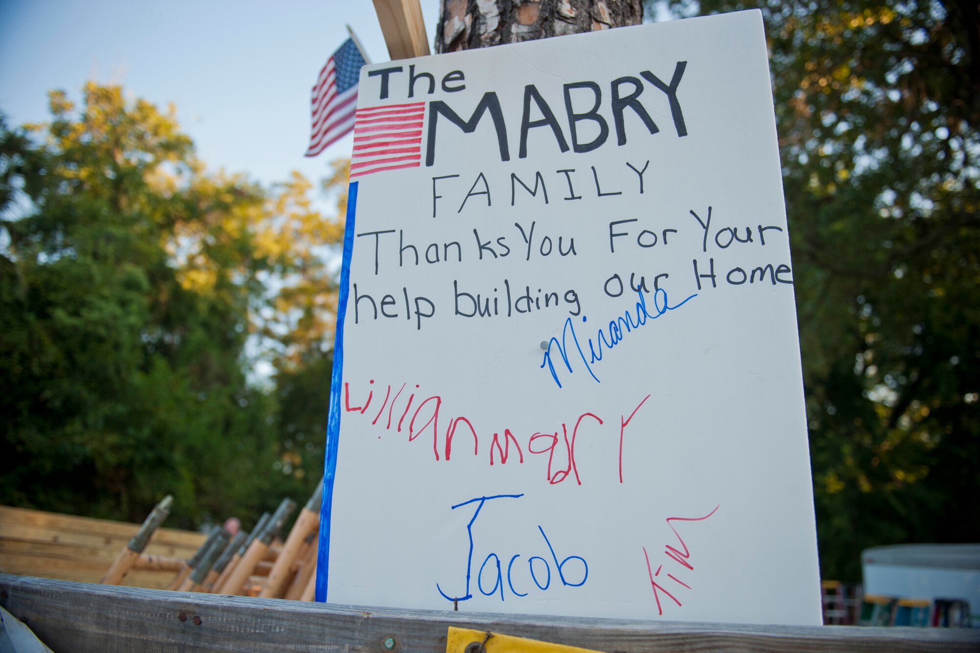 A “thank you” sign created by the Mabry family hangs on a tree outside of the construction zone of the 2nd Annual Valdosta-Lowndes County Habitat for Humanity Freedom Build in Valdosta, Ga., Sept. 10, 2011. This was the family’s second year applying for the program. They will be moving into a five-bedroom home. (U.S. Air Force photo by Staff Sgt. Jamal D. Sutter/Released)