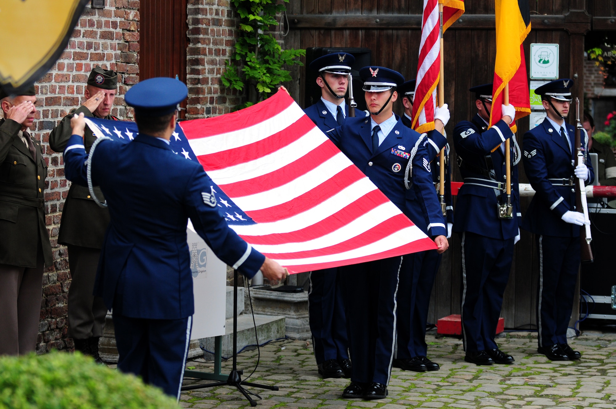 BORLO, Belgium – 52nd Fighter Wing Honor Guard members Staff Sgt. Victor Estupinan, left, and Staff Sgt. Charles Lopez perform a flag-folding ceremony during a Belgian 9-11 memorial here Sept. 11 U.S. service members and Belgian World War II Honor Guard Team members, along with the local community, participated in this ceremony as part of the Belgian Open Monument Day in remembrance of the victims of the Sept. 11, 2001 terrorist attacks on the United States. (U.S. Air Force photo/Airman 1st Class Matthew B. Fredericks)