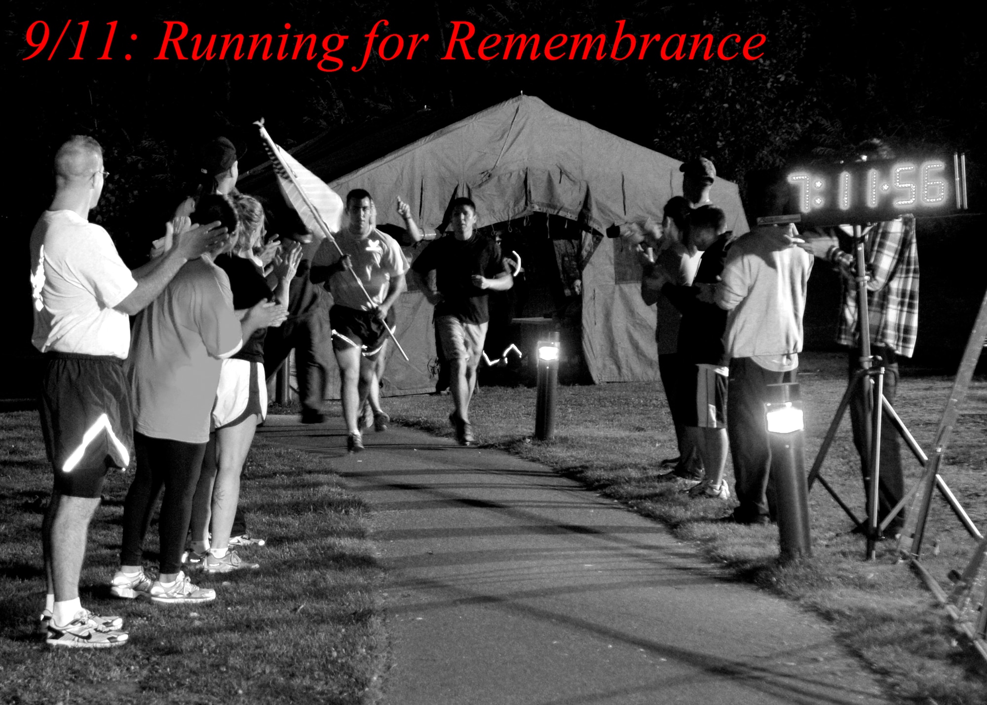 ROYAL AIR FORCE LAKENHEATH, England - Airmen and families cheer Liberty Warriors run the trail at Peacekeeper Park during the 24-hour Memorial Run, Sept. 10, 2011. The run, in remembrance of those that lost their lives in the 9/11 attacks, ended at 1:46 p.m. on Sept. 11, 2011, the time the first tower was hit. (U.S. Air Force photo illustration by Senior Airman Tiffany M. Deuel)