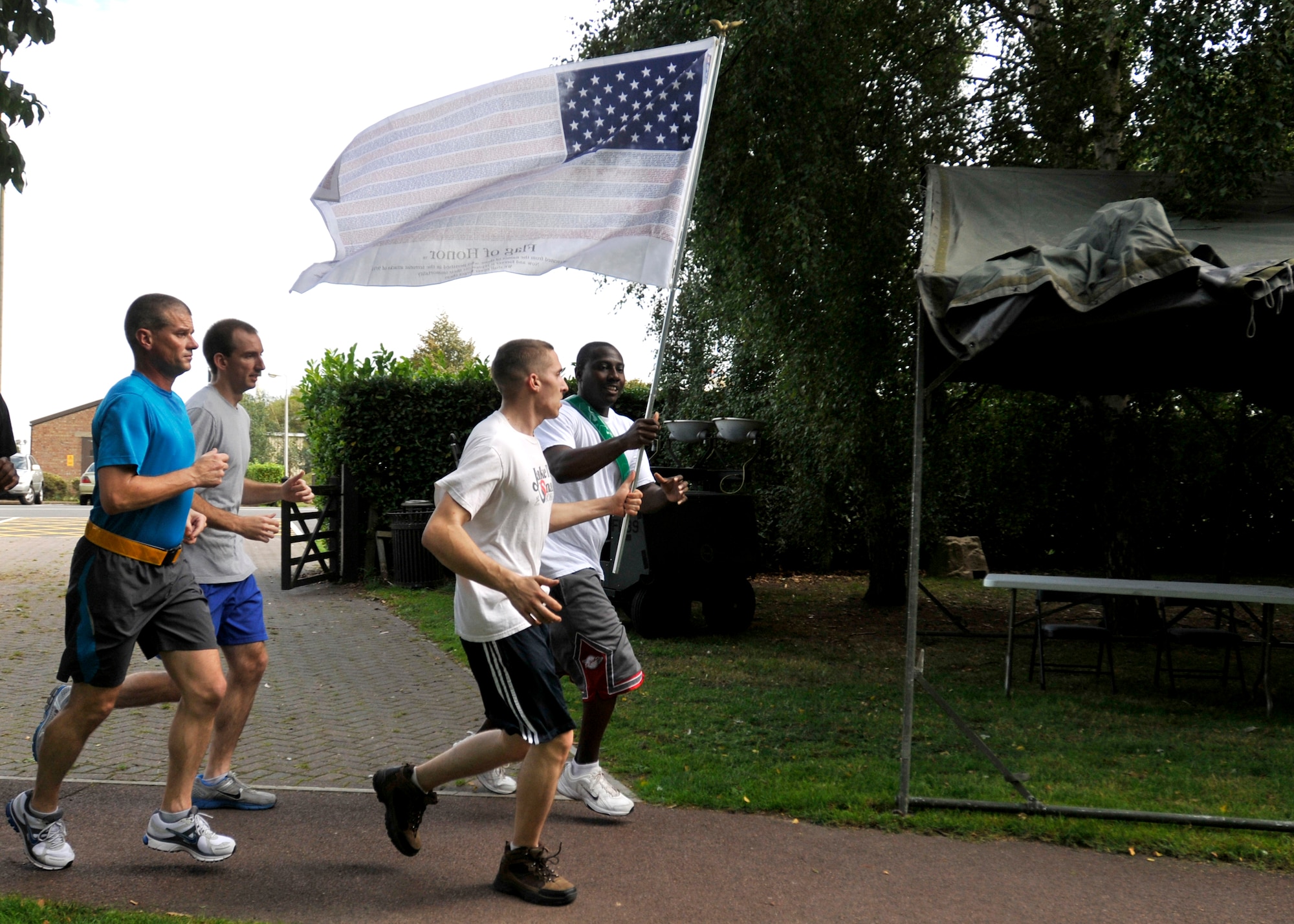 ROYAL AIR FORCE LAKENHEATH, England - Liberty Warriors run the trail at Peacekeeper Park during the 24-hour Memorial Run, Sept. 10, 2011. The run, in remembrance in those that lost their lives in the 9/11 attacks, ended at 1:46 p.m. on Sept. 11, 2011, the time the first tower was hit. (U.S. Air Force photo by Senior Airman Tiffany M. Deuel)