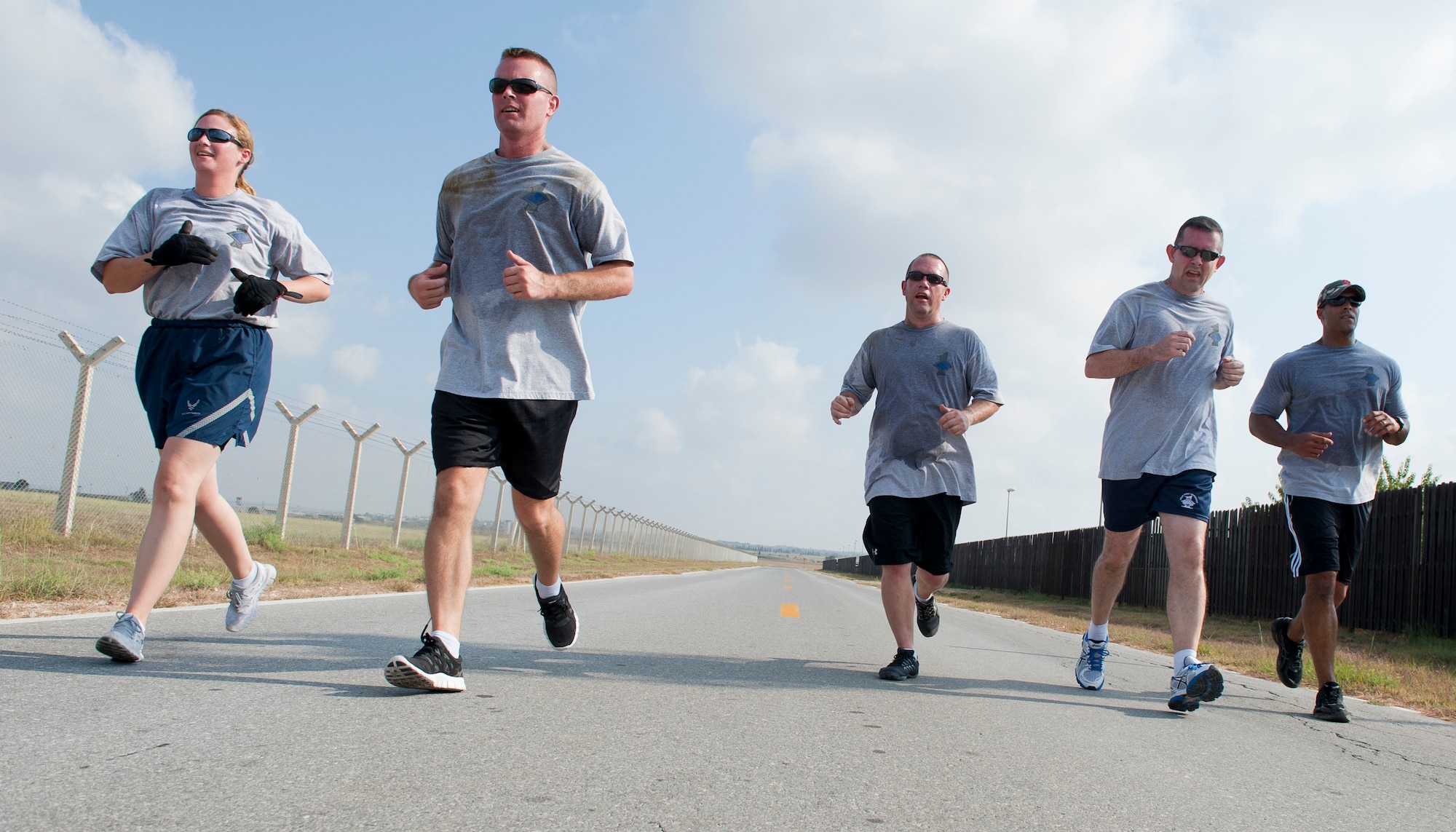 The first sergeants team runs together in the final sprint during the 10th Anniversary of 9/11 Combat Endurance Challenge Sept. 10, 2011, at Incirlik Air Base, Turkey. The challenge contained six events including push-ups and sit-ups, sandbag carry, rucksack run, Airman's Manual test questions, litter carry and final sprint to the finish line. The 39th Logistical Readiness Squadron hosts the annual challenge to raise money for the National September 11 Memorial and Museum. (U.S. Air Force photo by Senior Airman Anthony Sanchelli)

