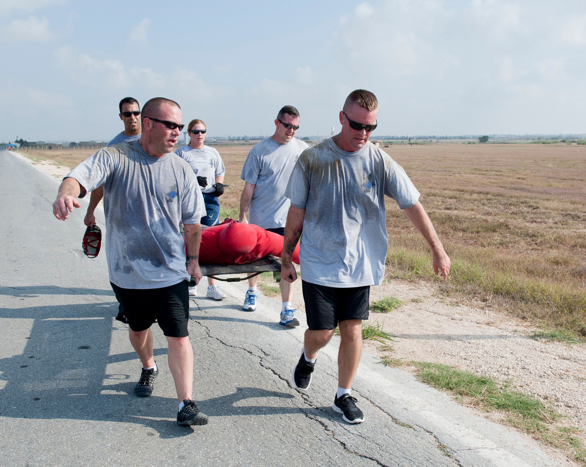 The first sergeants team hurries down the road while carrying a litter during the 10th Anniversary of 9/11 Combat Endurance Challenge Sept. 10, 2011, at Incirlik Air Base, Turkey. The challenge contained six events including push-ups and sit-ups, sandbag carry, rucksack run, Airman's Manual test questions, litter carry and final sprint to the finish line. The 39th Logistical Readiness Squadron hosts the annual challenge to raise money for the National September 11 Memorial and Museum. (U.S. Air Force photo by Senior Airman Anthony Sanchelli)