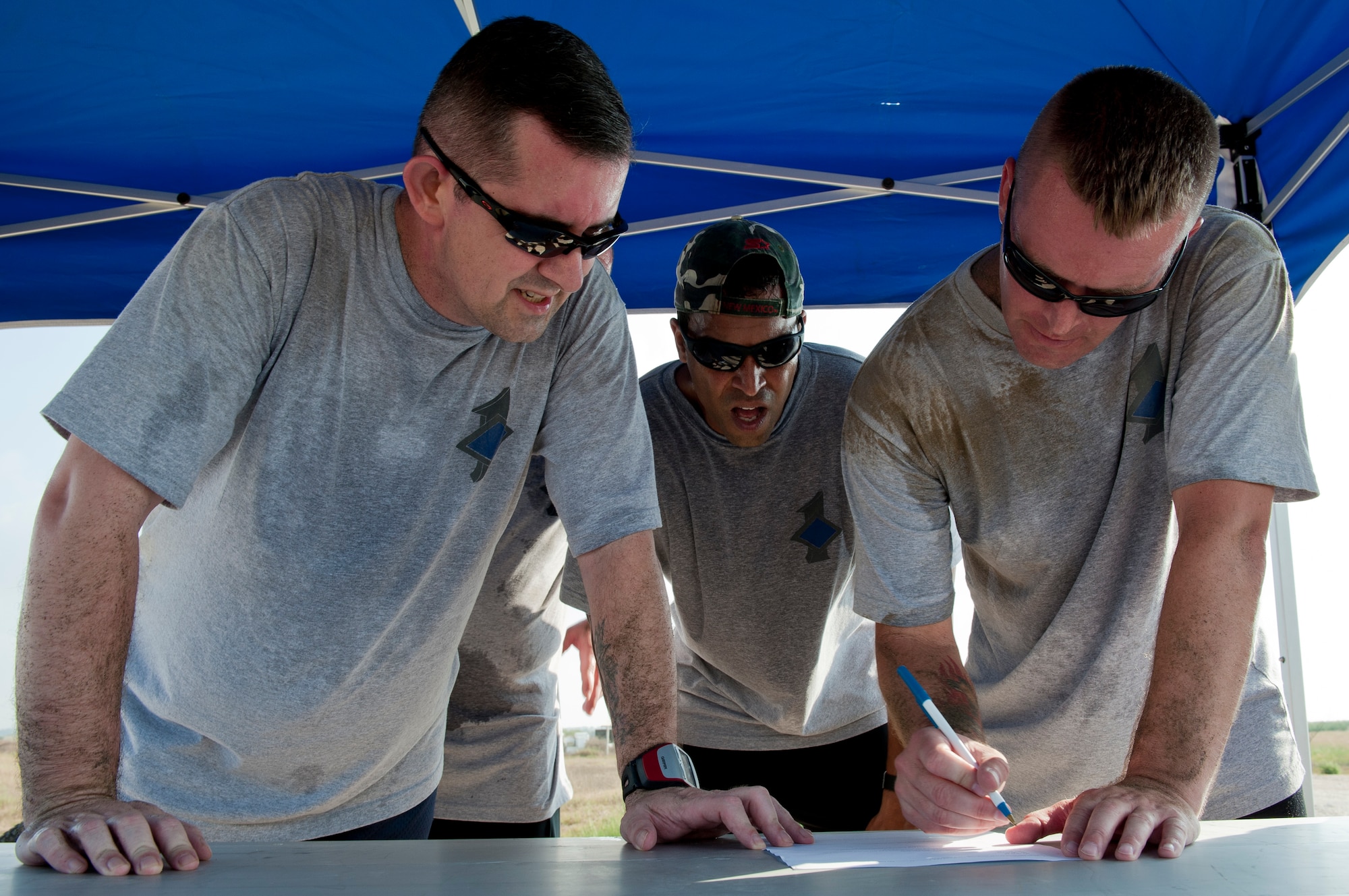 Left to right, Senior Master Sgt. Phillip Wilson, 39th Security Forces Squadron first sergeant; Master Sgt. Alan Weary, 39th Medical Group first sergeant; and Master Sgt. Michael Mujwid, 39th Maintenance Squadron first sergeant, answer test questions from the Airman's Manual during the 10th Anniversary of 9/11 Combat Endurance Challenge Sept. 10, 2011, at Incirlik Air Base, Turkey. The challenge contained six events including push-ups and sit-ups, sandbag carry, rucksack run, Airman's Manual test questions, litter carry and final sprint to the finish line. The 39th Logistical Readiness Squadron hosts the annual challenge to raise money for the National September 11 Memorial and Museum. (U.S. Air Force photo by Senior Airman Anthony Sanchelli)
