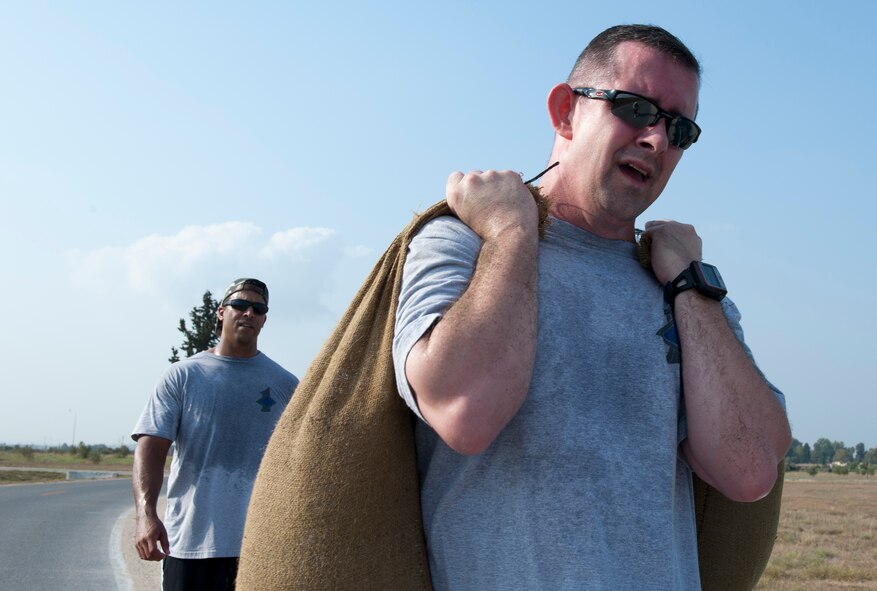 Senior Master Sgt. Phillip Wilson, 39th Security Forces Squadron first sergeant, right, lugs two sand bags during the 10th Anniversary of 9/11 Combat Endurance Challenge Sept. 10, 2011, at Incirlik Air Base, Turkey. The challenge contained six events including push-ups and sit-ups, sandbag carry, rucksack run, Airman's Manual test questions, litter carry and final sprint to the finish line. The 39th Logistical Readiness Squadron hosts the annual challenge to raise money for the National September 11 Memorial and Museum. (U.S. Air Force photo by Senior Airman Anthony Sanchelli)