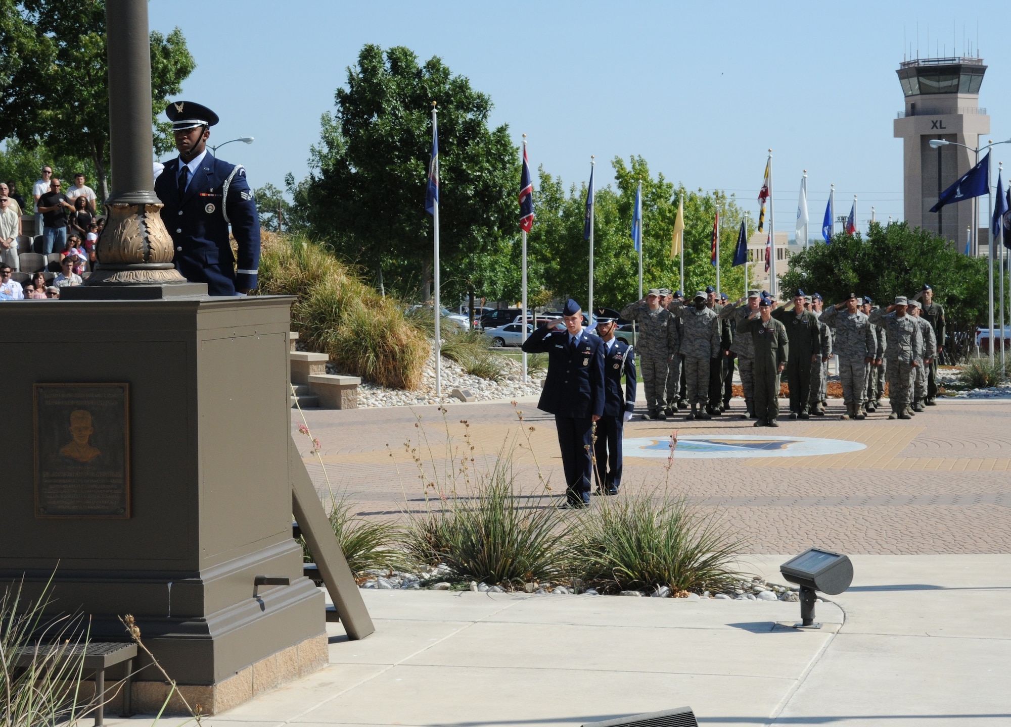 LAUGHLIN AIR FORCE BASE, Texas – Senior Airman Reggie Randolph, 47th Medical Operations Squadron, raises the U.S. flag during Laughlin’s 9/11 Remembrance Ceremony at Heritage Park here Sept. 11 as a flight of Laughlin Airmen salute. Dozens of Laughlin members and Del Rio citizens turned out to honor those who perished 10 years ago on Sept. 11, 2001. (U.S.  Air Force photo/Airman 1st Class Blake Mize) 
