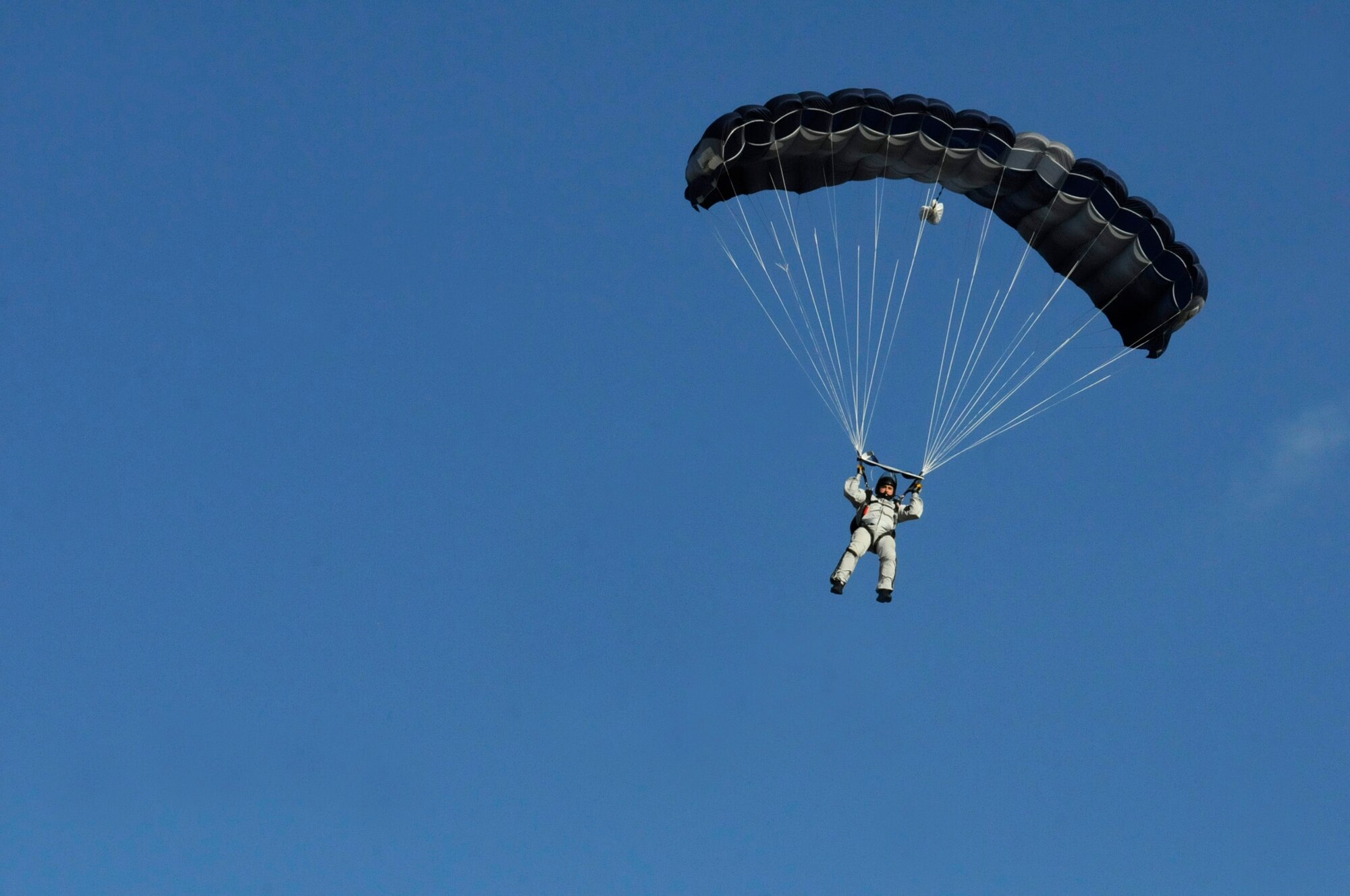 Air Force Tech. Sgt. Ed Dawejko, freefall jumpmaster, 603rd Air Operations Center, prepares to land after a high altitude, low opening (HALO) jump out of a C-130J Super Hercules over Powidz, Poland, September 5, 2011. This jump was conducted as part of Operation Screaming Eagle, a 10 day off-station training exercise where members of U.S. military join their Polish counterparts to train together and strengthen partnerships. (U.S. Air Force photo by Staff Sgt. Michael E. Davis)