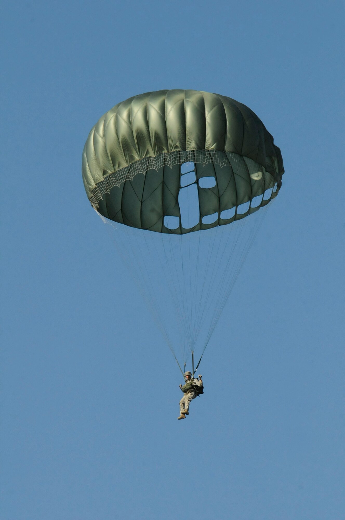 Air Force Staff Sgt. Nickolas Hurst, jumpmaster, 435th Security Forces Squadron, prepares to land after a static line jump out of a C-130J Super Hercules over an airfield in Powidz, Poland, Sept. 5, 2011. This jump was conducted as part of Operation Screaming Eagle, a 10 day off-station training exercise where members of U.S. military join their Polish counterparts to train together and strengthen partnerships. (U.S. Air Force photo by Staff Sgt. Michael E. Davis)