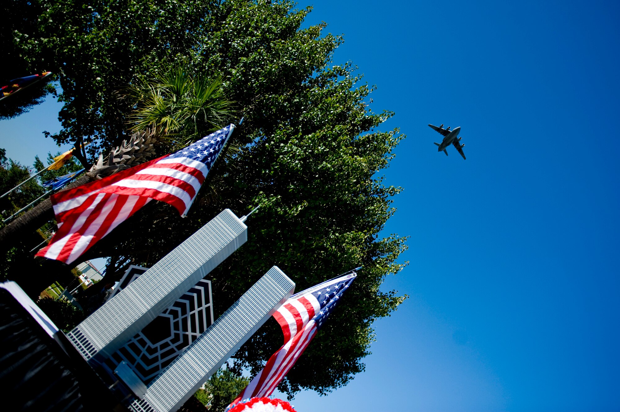A Joint Base Charleston C-17A Globemaster III performs a fly-over during a Retreat ceremony to commemorate the 10th anniversary of the 9/11 attacks, Sept. 9 at JB CHS - Air Base. During the ceremony, a 9/11 monument (show here) constructed by members of the 437th Maintenance Squadron, was unveiled. (U.S. Air Force photo/ Staff Sgt. Greg Biondo) 
