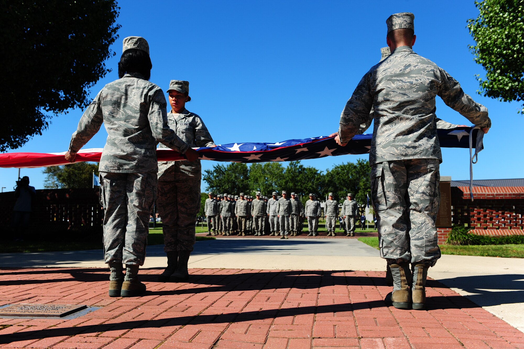 Members of the Joint Base Honor Guard fold the American flag during a Retreat ceremony commemorating the 10th anniversary of the 9/11 attacks, Sept. 9 at JB Charleston - Air Base. (U.S. Air Force photo/Airman 1st Class Jodi Martinez)