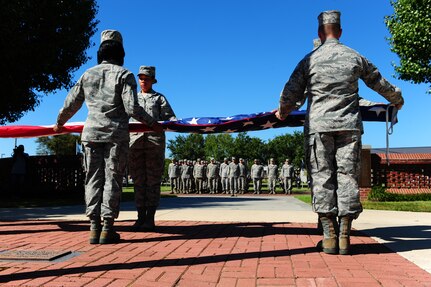 Members of the Joint Base Honor Guard fold the American flag during a Retreat ceremony commemorating the 10th anniversary of the 9/11 attacks, Sept. 9 at JB Charleston - Air Base. (U.S. Air Force photo/Airman 1st Class Jodi Martinez)