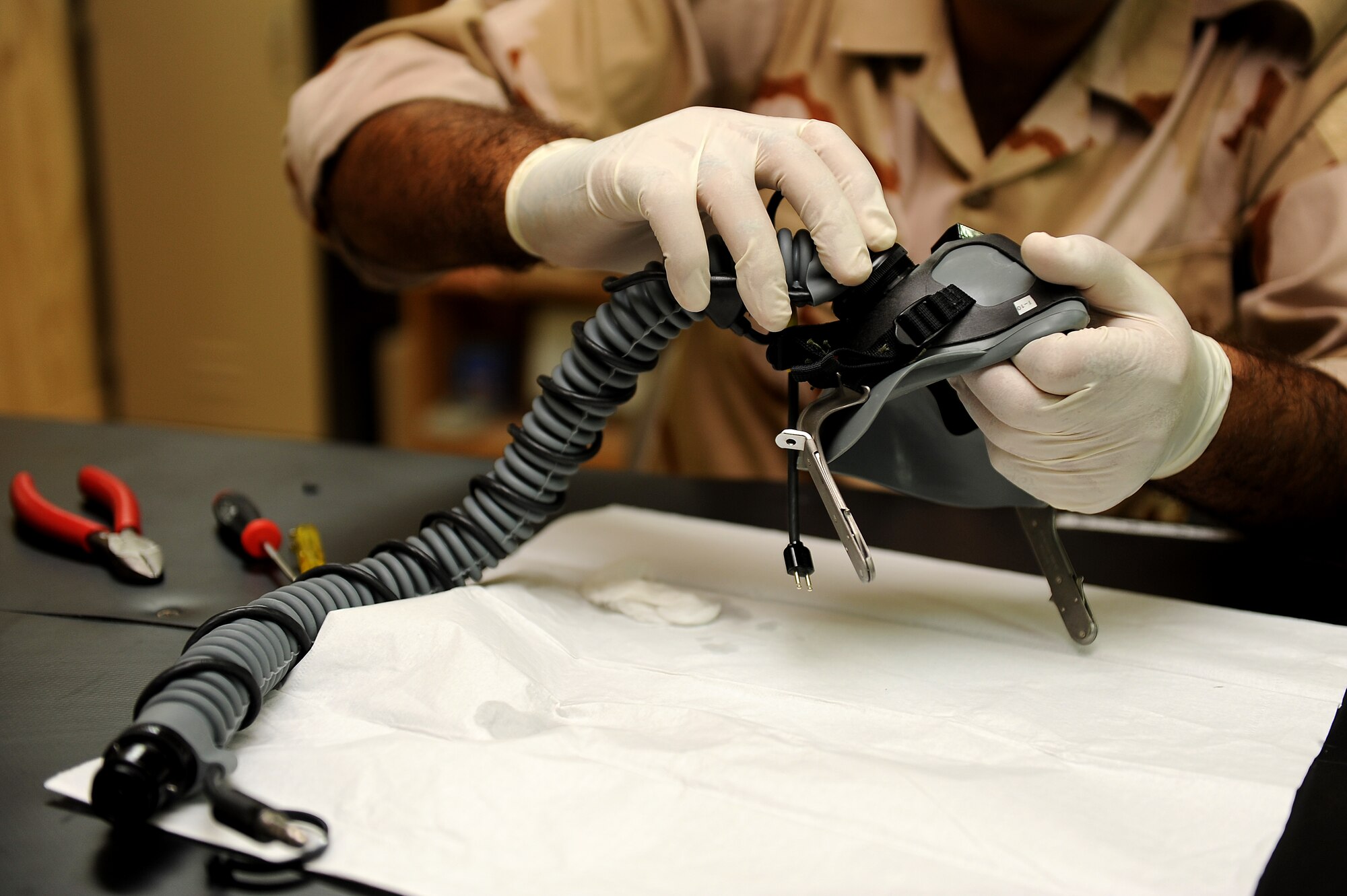 An Iraqi air force aircrew flight equipment technician, Iraqi air force Squadron 203, performs maintenance on a flight mask Sept. 5, 2011, at Camp Speicher, Iraq. Aircrew flight equipment Airmen from the 52nd Expeditionary Flight Training Squadron trained a team of enlisted men to maintain the flight equipment. The 52nd EFTS turned over flight training operations to the Iraqi air force. (U.S. Air Force photo/Staff Sgt. Mike Meares)