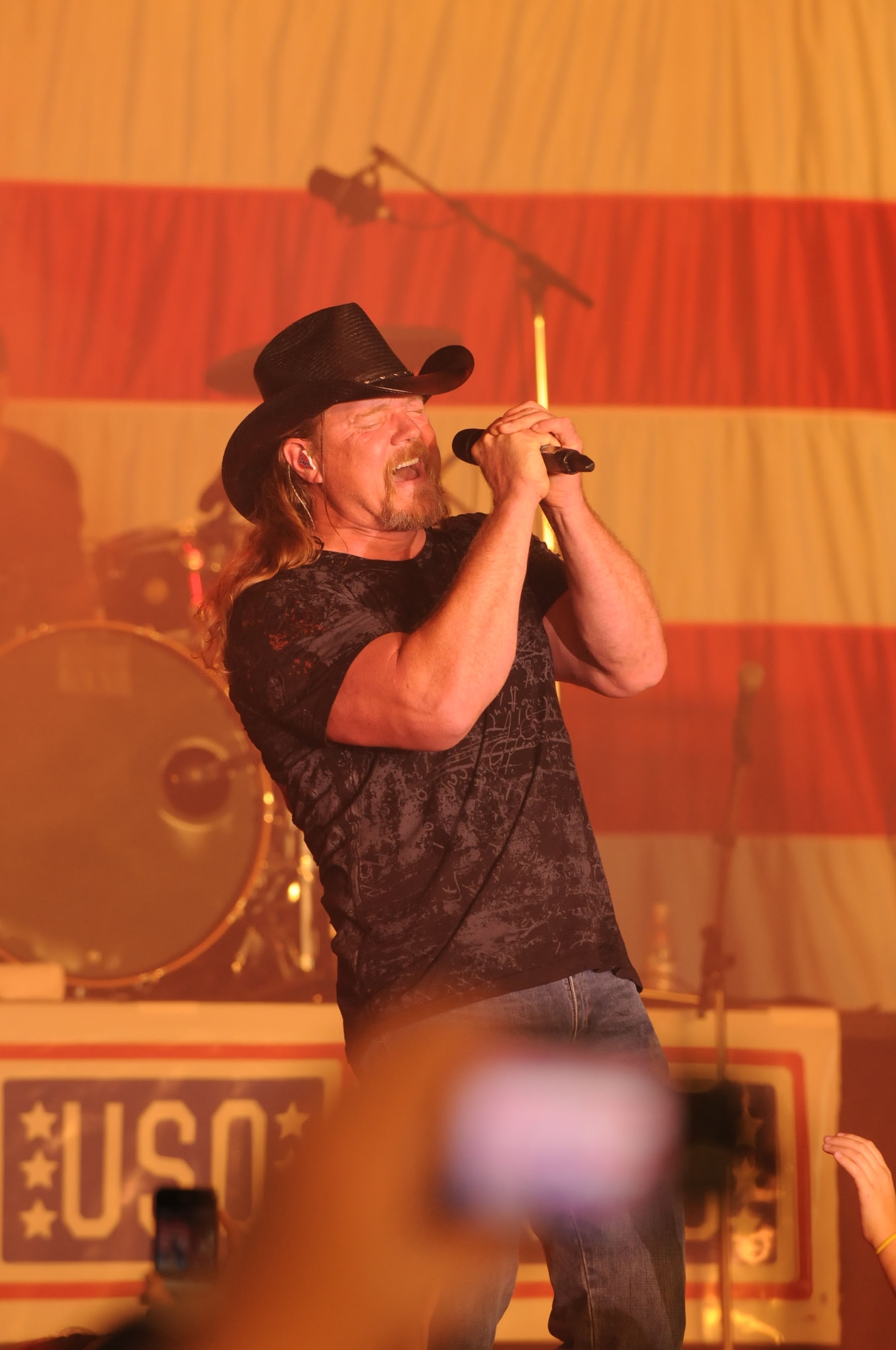 Trace Adkins, singer, song writer and entertainer, performs during a USO sponsored concert, Ramstein Air Base, Germany, Sept. 11, 2011. The Trace Adkins concert was designed to entertain and help boost the morale of troops and their families. (U.S. Air Force photo by Airman 1st Class Kendra Alba)