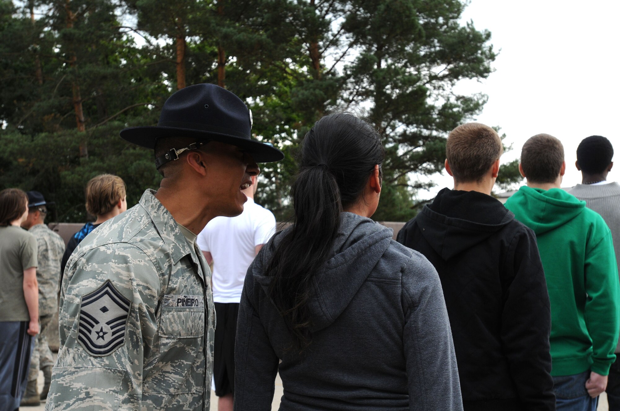 Air Force Senior Master Sgt. Manny Pineiro, 3rd Air Force first sgt., instructs a member of the Delayed Entry Program to use a reporting statement during a Commander's Call, Ramstein Air Base, Germany, Sept. 8, 2011. Former Military Training Instructors were brought to the Commander's Call to give DEP members a feel of what they will experience on their first night of basic military training. (U.S. Air Force photo by Airman 1st Class Kendra Alba)