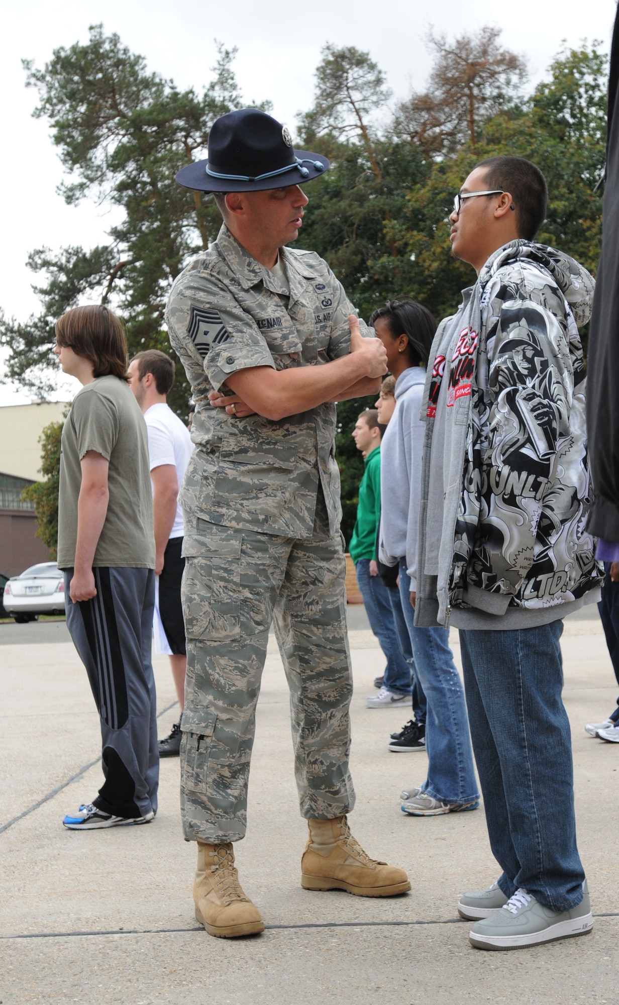 Air Force Chief Master Sgt. Adam McNair, United States Air Forces in Europe first sgt., speaks to a Delayed Entry Program member during a Commander's Call, Ramstein Air Base, Germany, Sept. 8, 2011. Former Military Training Instructors were brought to the Commander's Call to give DEP members a feel of what they will experience on their first night of basic military training. (U.S. Air Force photo by Airman 1st Class Kendra Alba)