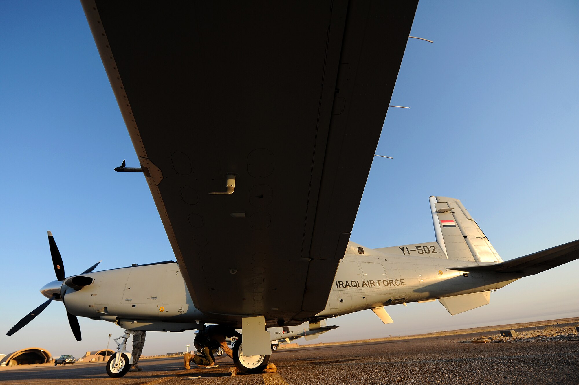 An Iraqi air force pilot, Squadron 203, does a pre-flight inspection on a T-6 Texan II Sept. 4, 2011, at Camp Speicher, Iraq. The 52nd Expeditionary Flying Training Squadron turned over flight operations to the IqAF Sept. 5. The T-6 is a single-engine, two-seater designed to train joint primary pilot training students in basic flying skills common to U.S. Air Force and Navy pilots, including six other countries. (U.S. Air Force photo/Staff Sgt. Mike Meares)