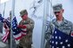 Senior Master Sgt. Dan Bouchee, 438th Air Expeditionary Wing first sergeant (far right) receives an American flag on the 10th Anniversary of 9/11. (U.S. Air Force photo by Senior Airman Amber Williams) 

