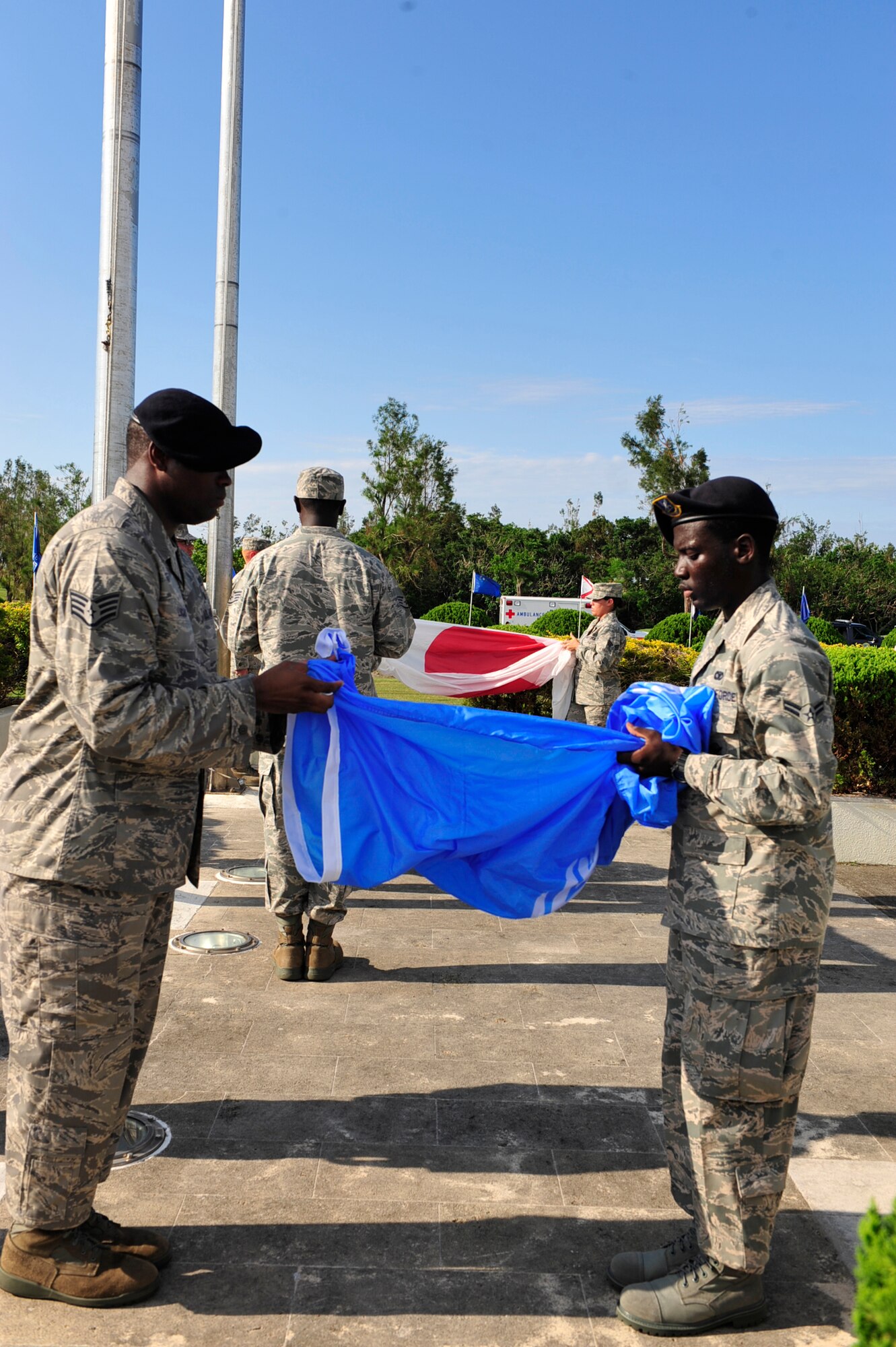 Members of the 18th Wing perform the retreat ritual during the 9/11 Remembrance Ceremony held at the 18th Wing headquarters building, Kadena Air Base, Japan, Sept 9. This year marks the ten year anniversary of the terrorist attacks on the Twin Towers and the Pentagon. (U.S. Air Force photo/ Tech. Sgt. Lakisha A. Croley)