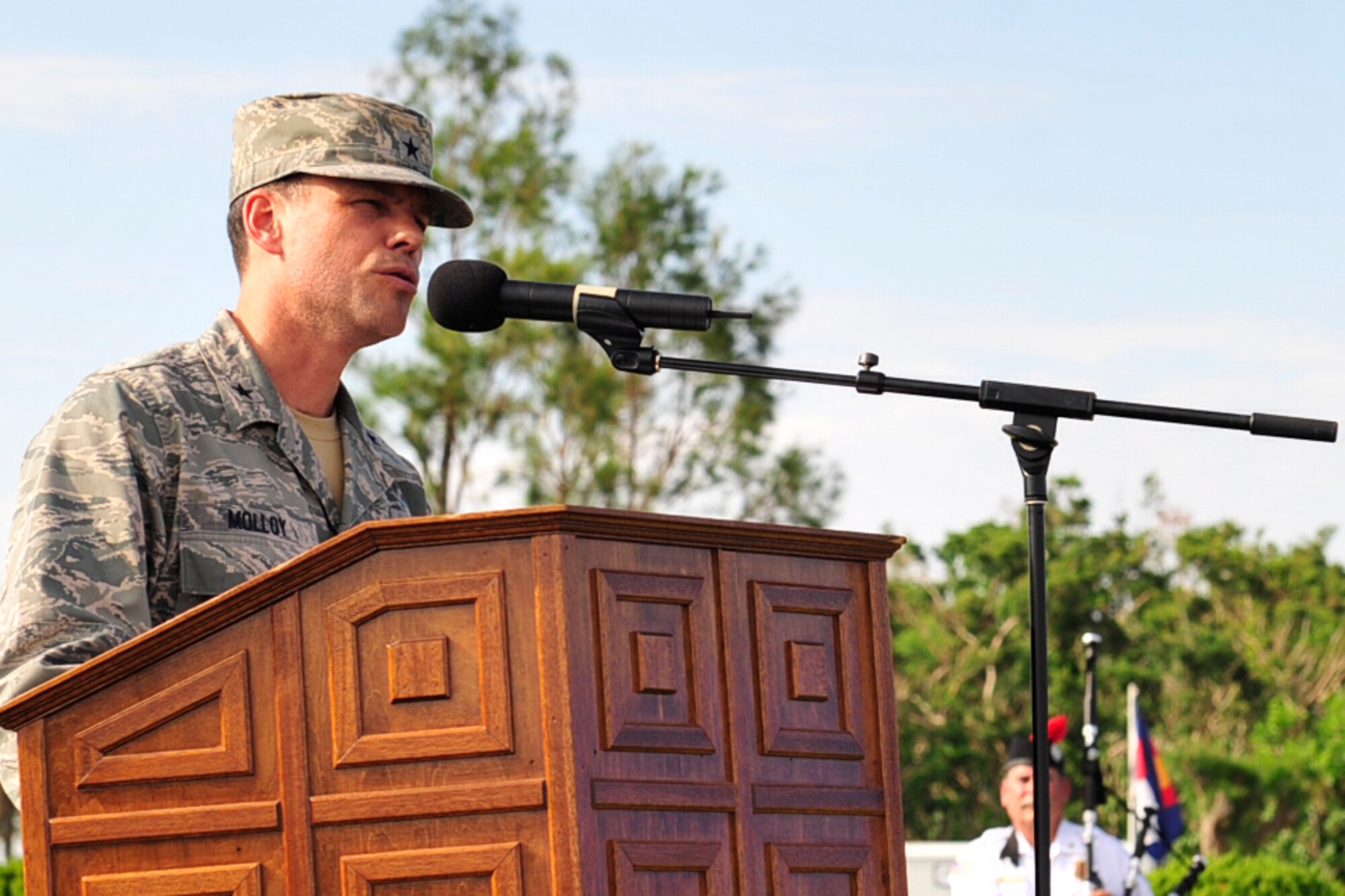Brig. Gen. Matt Molloy, 18th Wing commander, speaks to members of Team Kadena and the local community during the 9/11 Remembrance Ceremony held at the Wing headquarters building, Kadena Air Base, Japan Sept 9. Brig. Gen. Molloy was stationed at Kadena when 9/11 occurred. "I turned on the TV just as the second aircraft hit the building. It was a surreal event there: blue skies and bright sunlight; darkness and a raging typhoon named "Nari" railed outside here," stated Brig. Gen. Molloy as he told the attendees about his experience on that day. (U.S. Air Force photo/ Tech. Sgt. Lakisha A. Croley)