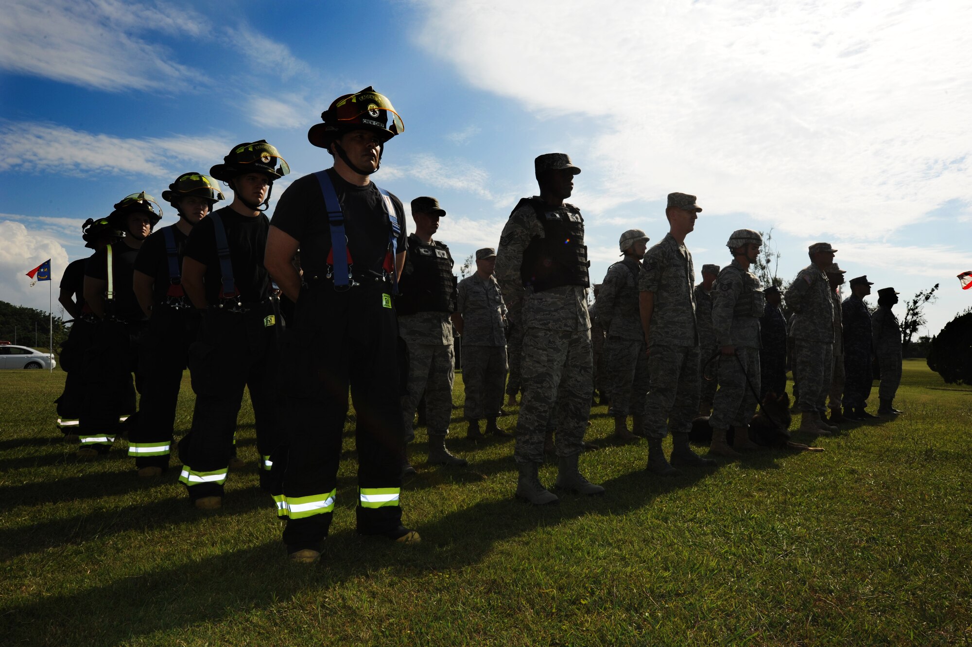Members of Team Kadena stand in formation during a 9/11 Remembrance Ceremony held at the 18th Wing headquarters building, Kadena Air Base, Japan Sept. 9. This year marked the ten year anniversary of the Twin Towers and Pentagon terrorist attacks which took the lives of almost 3,000 men, women and children. (U.S. Air Force photo/Tech. Sgt. Lakisha A. Croley)