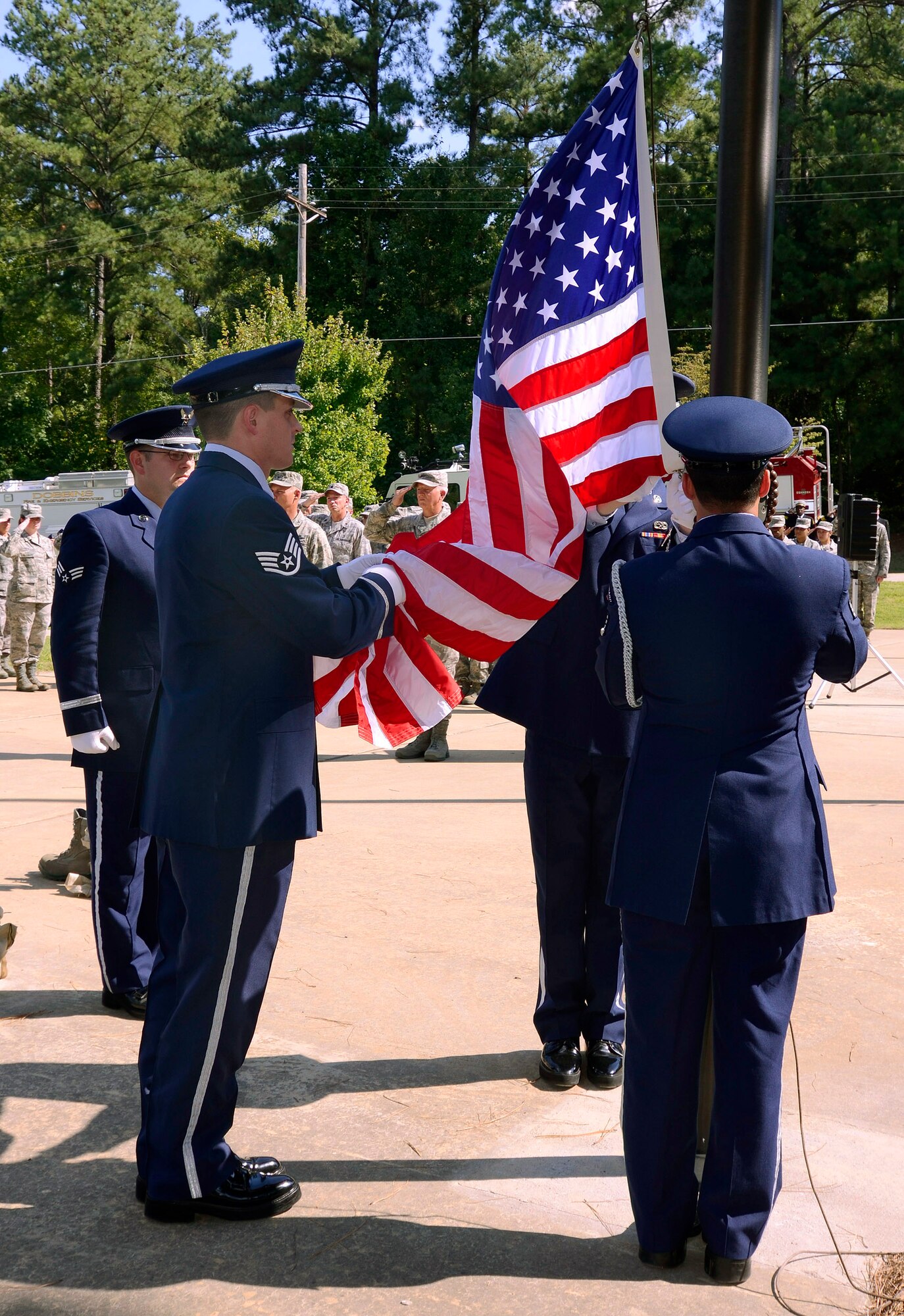 The 94th Airlift Wing Honor Guard flag detail lowers the U.S. flag at Dobbins Air Reserve Base during a retreat ceremony to honor the 10th anniversary of the 2001 terrorist attacks, Sept 11.   (U.S. Air Force photo/ Brad Fallin)