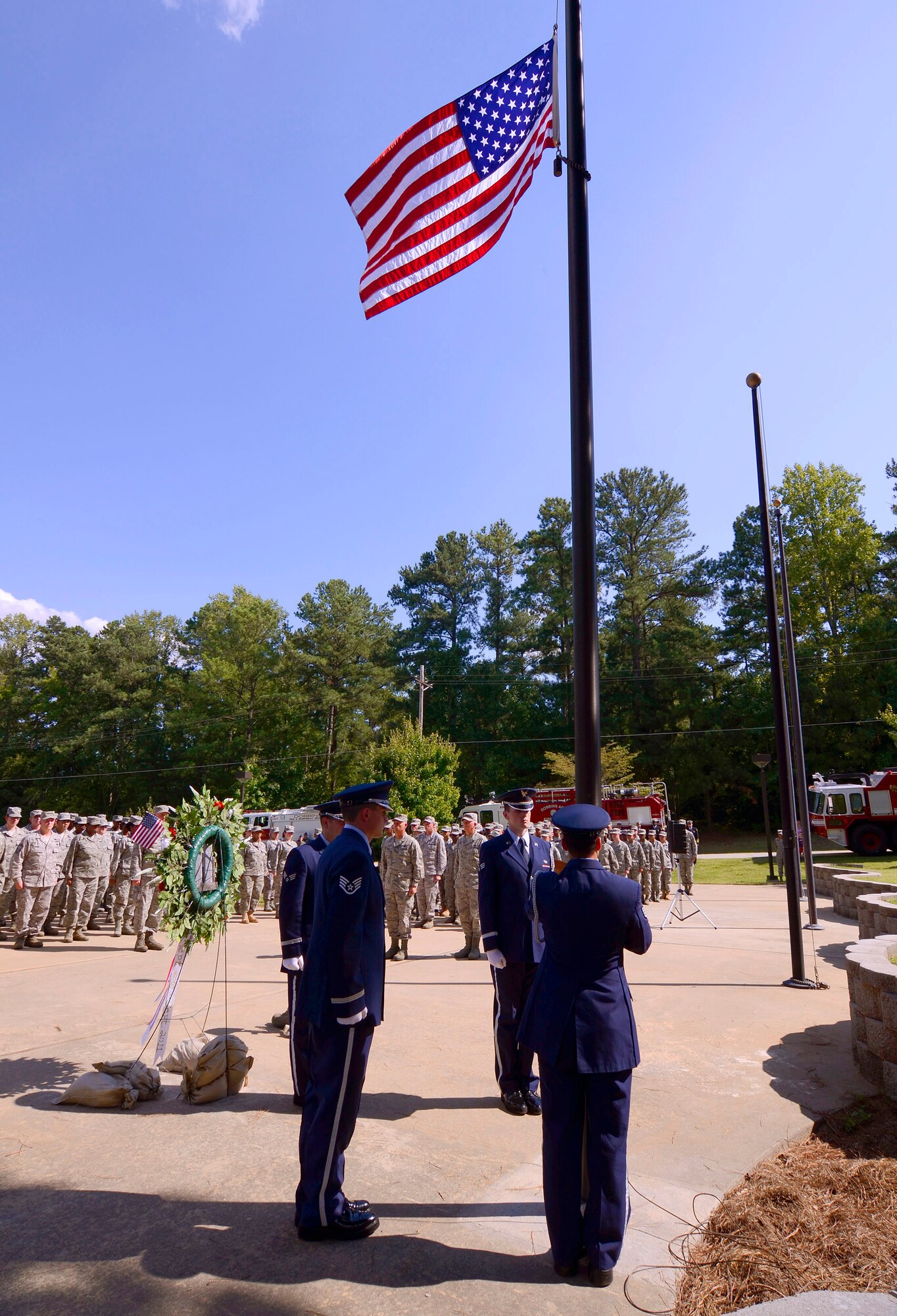 The 94th Airlift Wing Honor Guard flag detail lowers the U.S. flag at Dobbins Air Reserve Base during a retreat ceremony to honor the 10th anniversary of the 2001 terrorist attacks, Sept 11.   (U.S. Air Force photo/ Brad Fallin)