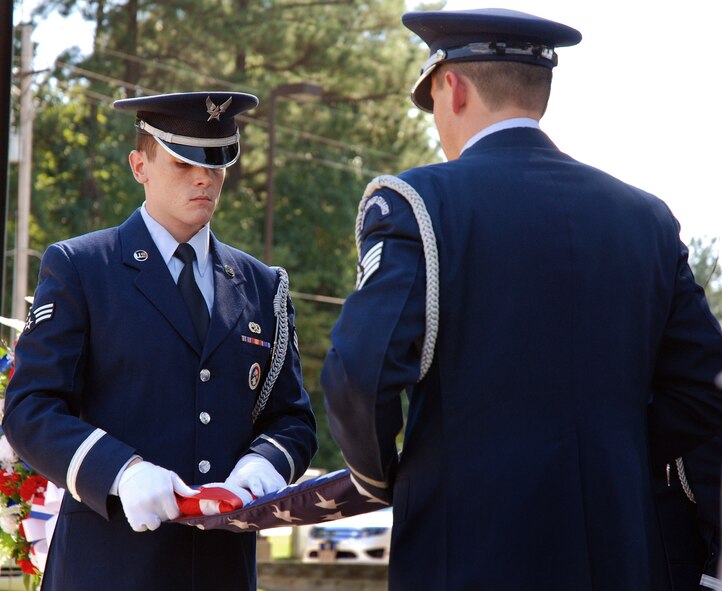 The 94th Airlift Wing Honor Guard flag detail folds the U.S. flag at Dobbins Air Reserve Base during a retreat ceremony to honor the 10th anniversary of the 2001 terrorist attacks, Sept 11.   (U.S. Air Force photo/ Senior Airman Spencer Gallien)