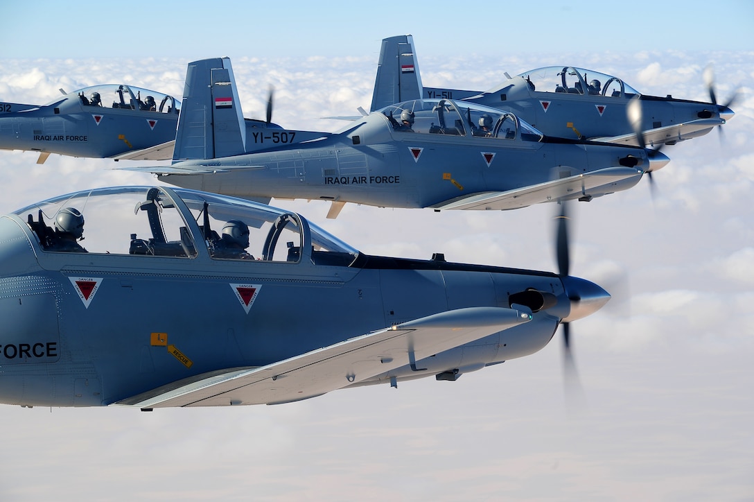 U.S. and Iraqi air force airmen fly in formation during one of the last training flights for the 52nd Expeditionary Flight Training Squadron and Squadron 203 Sept. 3, 2011, over Iraq. Advisors from the 52nd EFTS turned over flight training operations to the Iraqi air force Squadron 203 Sept. 5. The training program takes 18-month to qualify and certify an instructor pilot. (U.S. Air Force photo/Senior Airman Tyler Placie)