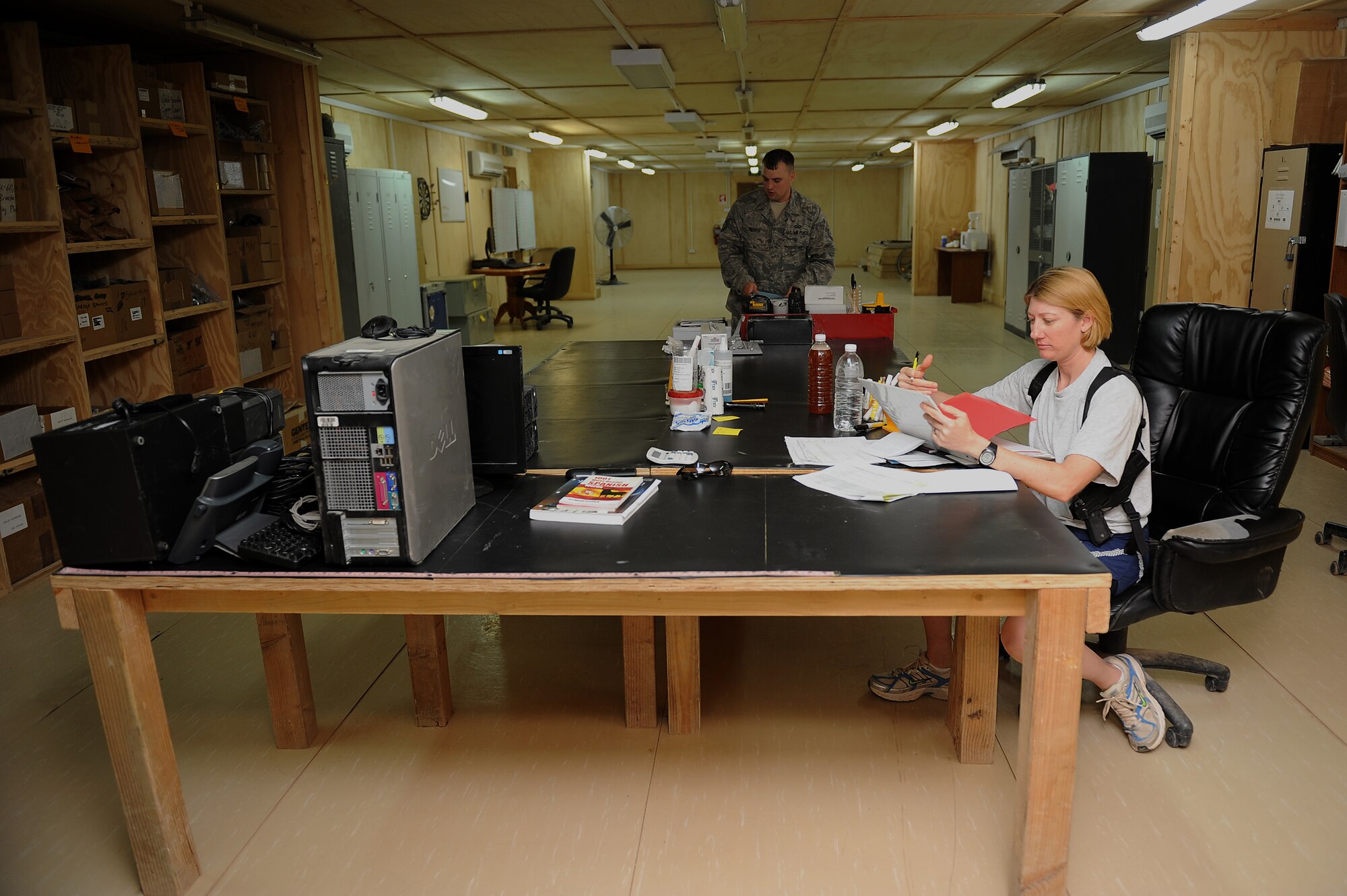 Master Sgt. Michelle Bell and Tech. Sgt. Chris Hoover, 52nd Expeditionary Flying Training Squadron aircrew flight equipment, organizes equipment for transition and turnover to the Iraqi air force Squadron 203 Aug. 31, 2011, at Camp Speicher, Iraq. The final flight training mission for the squadron was Sept. 5. Bell is from Brunswick, Ohio. (U.S. Air Force photo/Staff Sgt. Mike Meares)