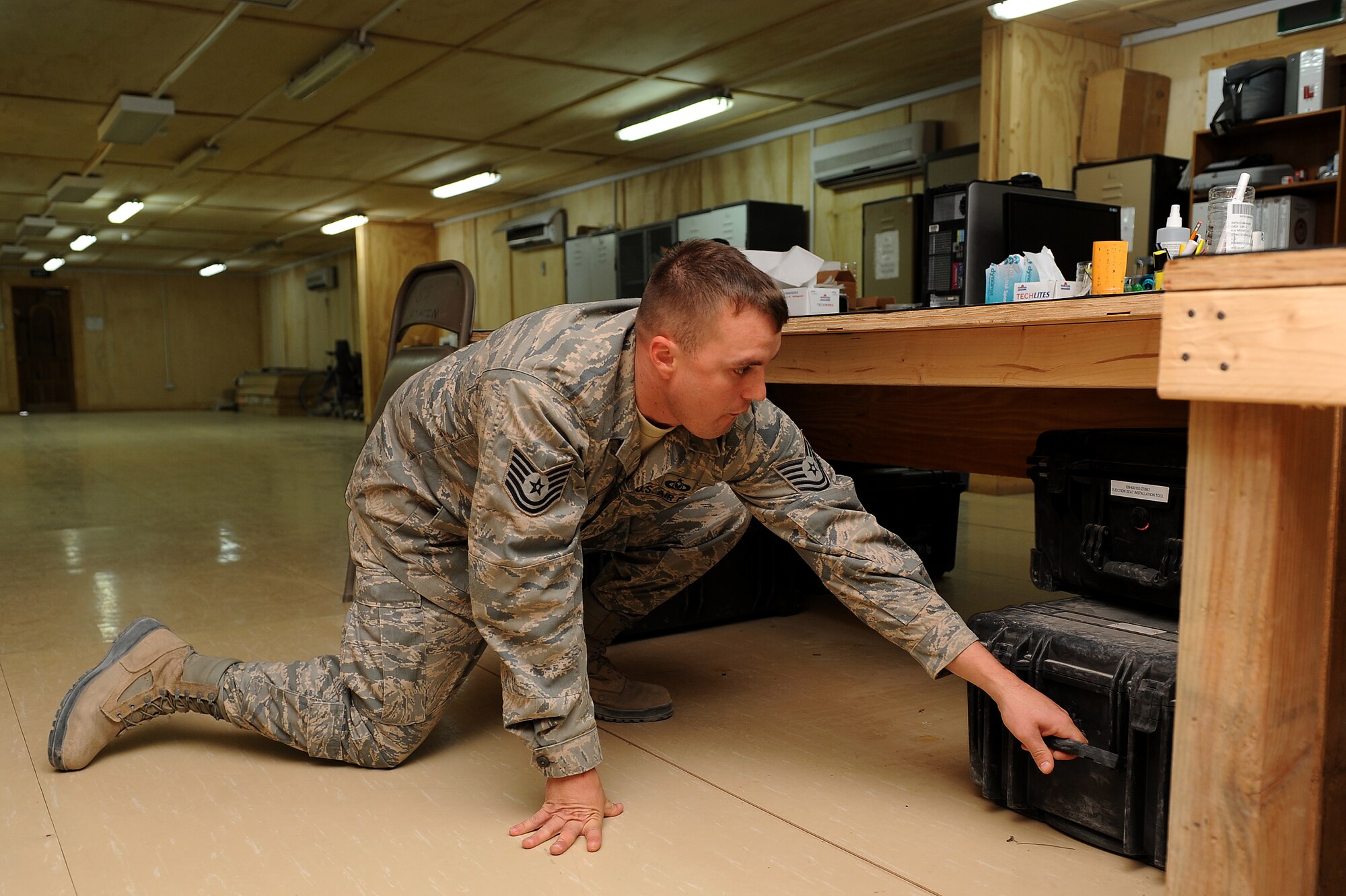 Tech. Sgt. Chris Hoover, 52nd Expeditionary Flying Training Squadron aircrew flight equipment technician, organizes gear in preparation for turnover to the Iraqi air force Squadron 203 Aug. 31, 2011, at Camp Speicher, Iraq. The final mission for the squadron was Sept. 5. Hoover was deployed in 2007 when the 52nd EFTS stood up at Kirkuk Air Base, Iraq. (U.S. Air Force photo/Staff Sgt. Mike Meares)