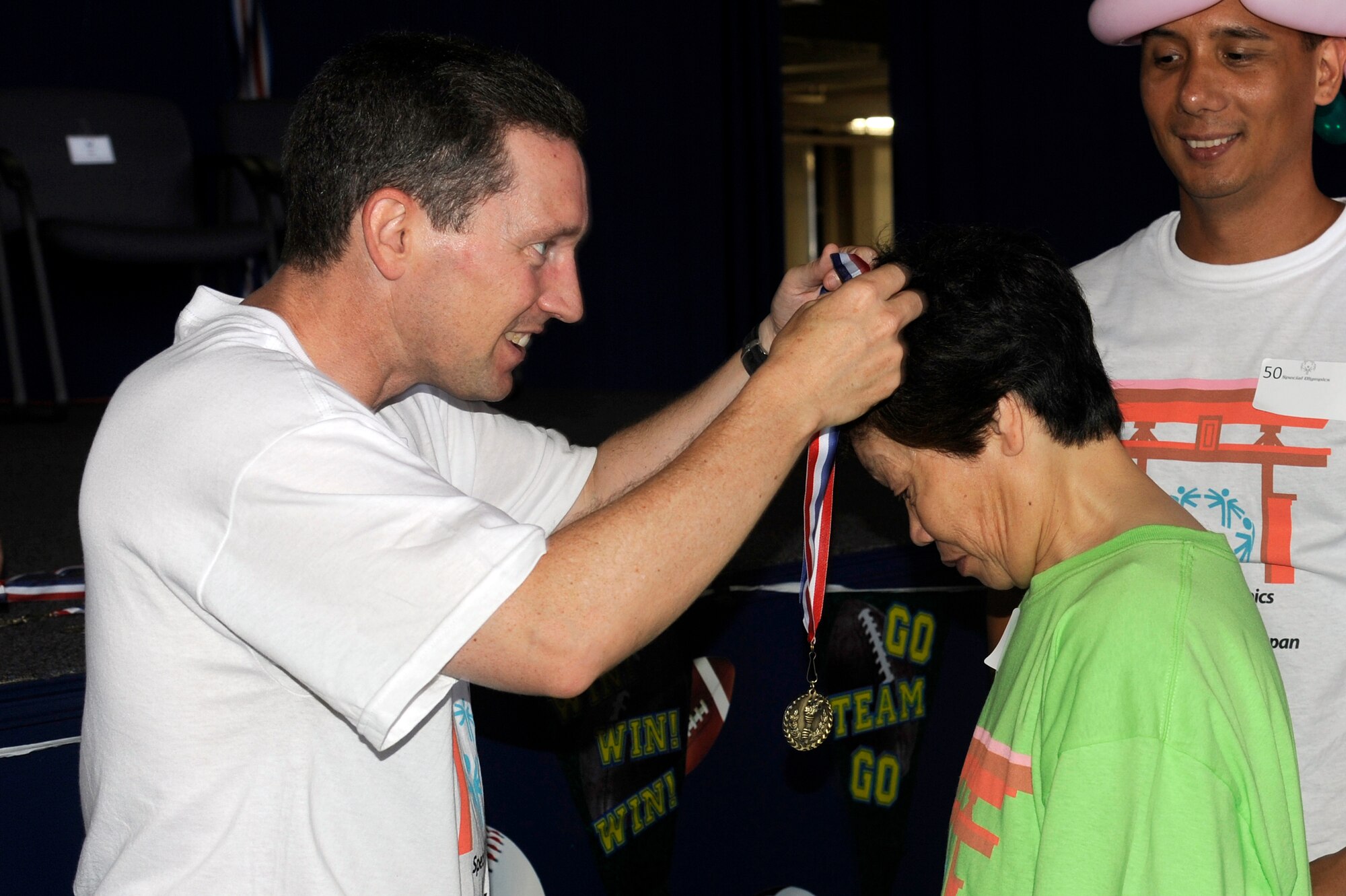 MISAWA AIR BASE, Japan - U.S. Air Force Col. Michael D. Rothstein, 35th Fighter Wing commander, presents an athlete with a medal during the annual Special Olympics here Sept. 10. Each athlete received a medal for their dedication and achievement. (U.S. Air Force photo/Tech. Sgt. Marie Brown)
