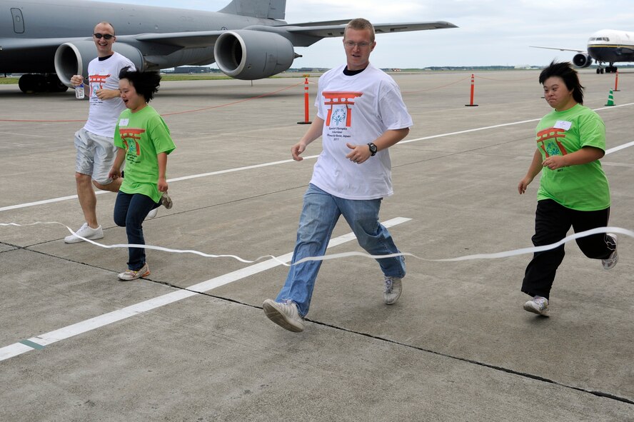 MISAWA AIR BASE, Japan - Special Olympic athletes along with their volunteers participate in a 25-meter dash during the annual Special Olympics here Sept. 10. Athletes participated in various activities including a bean bag toss, softball toss, football toss and frisbee toss. (U.S. Air Force photo/Tech. Sgt. Marie Brown)