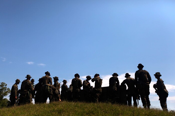 Marines and Sailors with 3rd Platoon, Charlie Company, 1st Battalion, 2nd Marine Regiment, look down range shortly before conducting Military Operations in Urban Terrain training at the Urban Assault Course on Fort Pickett, Va., Sep. 12, 2011. More than 900 Marines and Sailors are taking part in the Deployment for Training exercise at Fort Pickett, Sept. 6-23. The battalion is scheduled to attach to the 24th Marine Expeditionary Unit as its Battalion Landing Team a few days after the training.