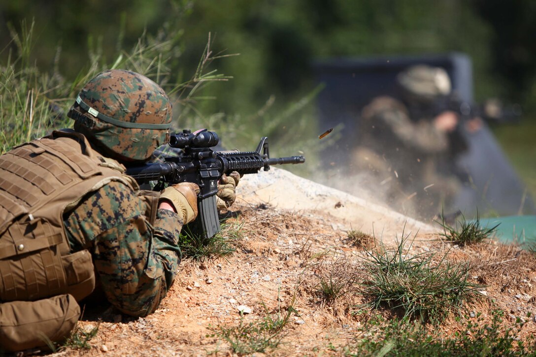 Staff Sgt. Patrick Hammer, the platoon sergeant for 3rd Platoon, Charlie Company, 1st Battalion, 2nd Marine Regiment, fires his weapon during Military Operations in Urban Terrain training at the Urban Assault Course on Fort Pickett, Va., Sep. 12, 2011. More than 900 Marines and Sailors are taking part in the Deployment for Training exercise at Fort Pickett, Sept. 6-23. The battalion is scheduled to attach to the 24th Marine Expeditionary Unit as its Battalion Landing Team a few days after the training.