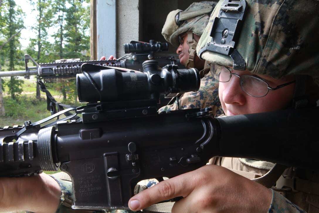 (Right) Pfc. Timothy Conner, a rifleman, and Seaman David Player, a hospital corpsman both with 1st Platoon, Charlie Company, 1st Battalion, 2nd Marine Regiment, take a defensive posture and provide security during Military Operations in Urban Terrain training at the Urban Assault Course on Fort Pickett, Va., Sep. 12, 2011. More than 900 Marines and Sailors are taking part in the Deployment for Training exercise at Fort Pickett, Sept. 6-23. The battalion is scheduled to attach to the 24th Marine Expeditionary Unit as its Battalion Landing Team a few days after the training.