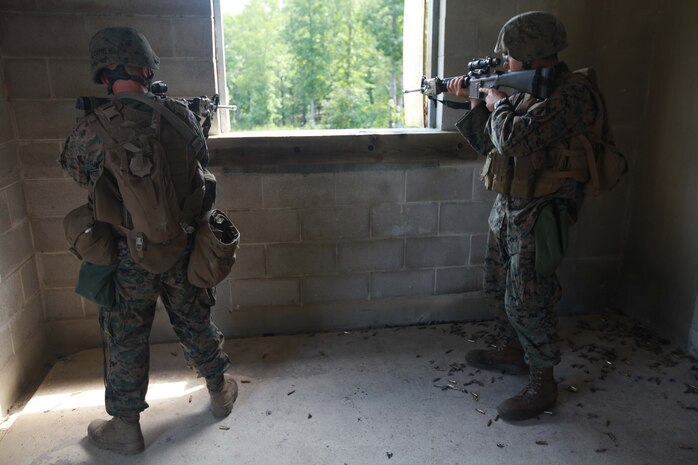 Marines with Charlie Company, 1st Battalion, 2nd Marine Regiment, take a defensive posture during Military Operations in Urban Terrain training at the Urban Assault Course on Fort Pickett, Va., Sept. 12, 2011. More than 900 Marines and Sailors are taking part in the Deployment for Training exercise at Fort Pickett, Sept. 6-23. The battalion is scheduled to attach to the 24th Marine Expeditionary Unit as its Battalion Landing Team a few days after the training.