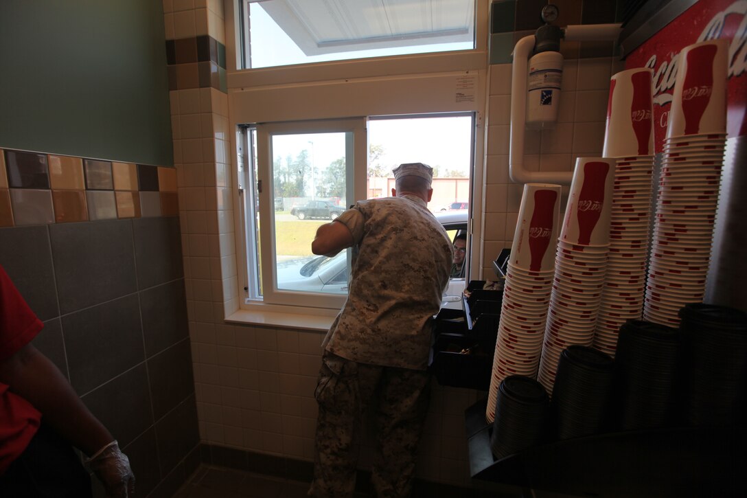 Col. Daniel J. Lecce, commanding officer for Marine Corps Base Camp Lejeune, talks to a Marine going through the drive-thru window of Messhall 128, Sept. 13. The new dining facility is slated to be Leadership in Energy and Environmental Design certified and is replacing a 1942 era messhall.