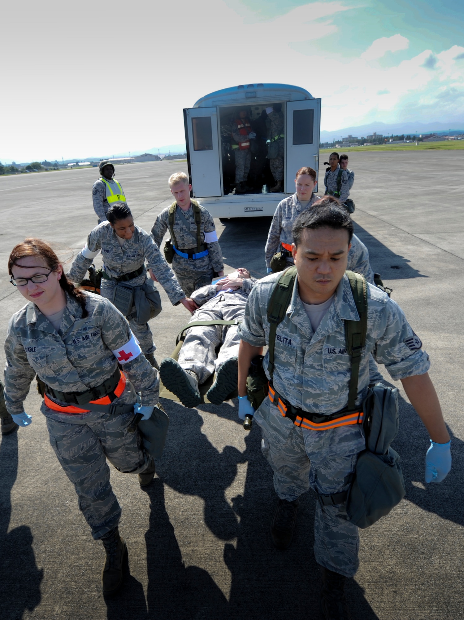 YOKOTA AIR BASE, Japan – Airmen from the 374th Medical Operations Squadron prepare and transport patients on litters during a simulated medical evacuation at Yokota Air Base, Japan, Sept. 13, 2011. Yokota is participating in wing readiness exercise. (U.S. Air Force photo/Staff Sgt. Stacy Moless)