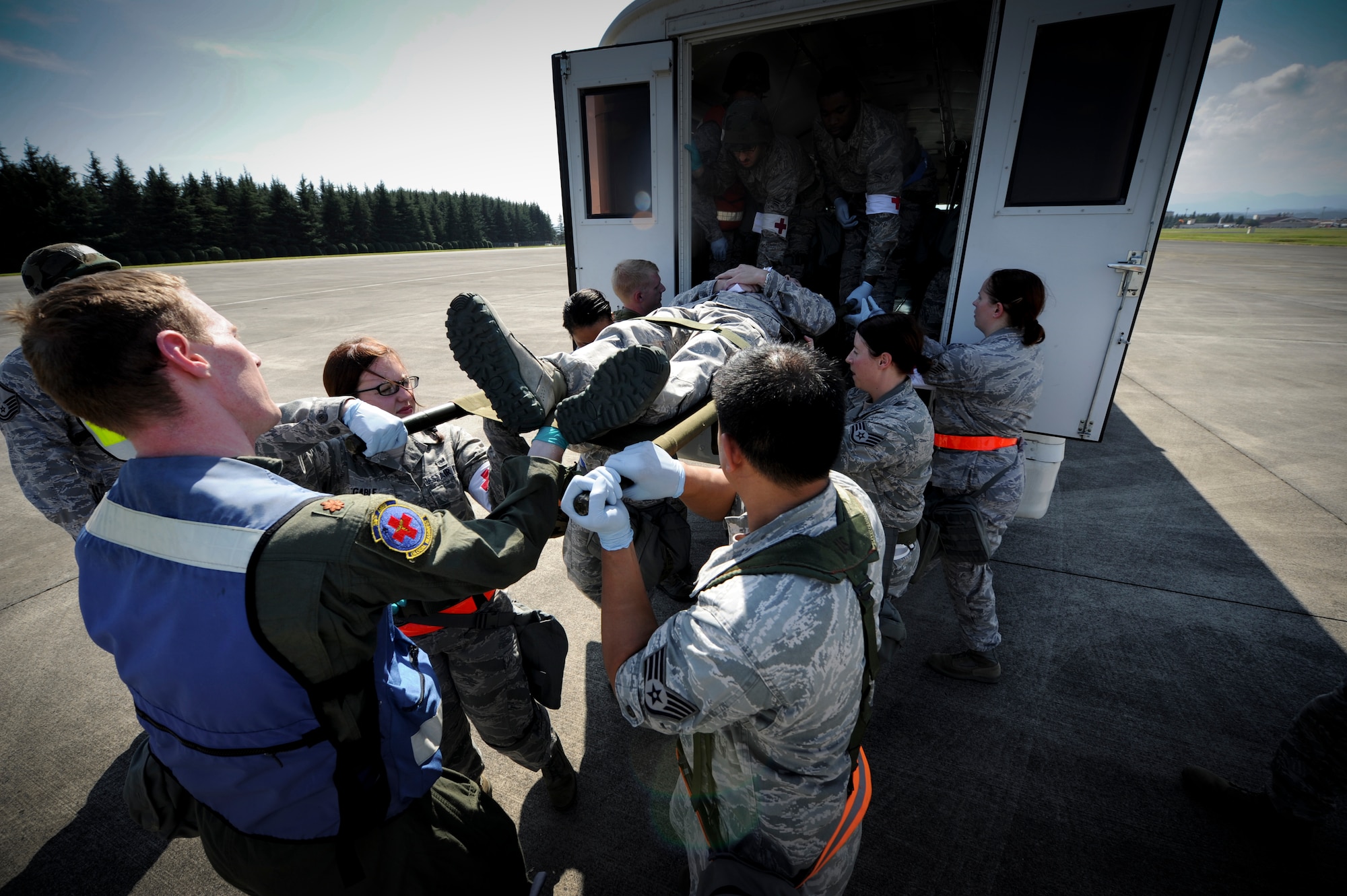 YOKOTA AIR BASE, Japan – Airmen from the 374th Medical Operations Squadron prepare and transport patients on litters during a simulated medical evacuation at Yokota Air Base, Japan, Sept. 13, 2011. Yokota is participating in a wing readiness exercise. (U.S. Air Force photo/Staff Sgt. Stacy Moless)