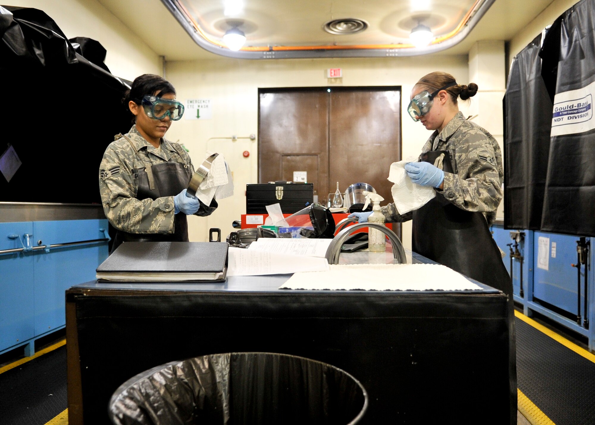 (Left) Senior Airman Karina Gonzalez, 51st Maintenance Squadron nondestructive inspection technician, and Airman 1st Class Nicole Calungsod, 51st Maintenance Squadron nondestructive inspection technician, clean aircraft parts before performing inspections on them Sept. 13, 2011. NDI is the examination of aerospace weapon systems components and support equipment for structural integrity using nondestructive inspection methods and fluid analysis. (U.S. Air Force Photo by/ Senior Airman Adam Grant)