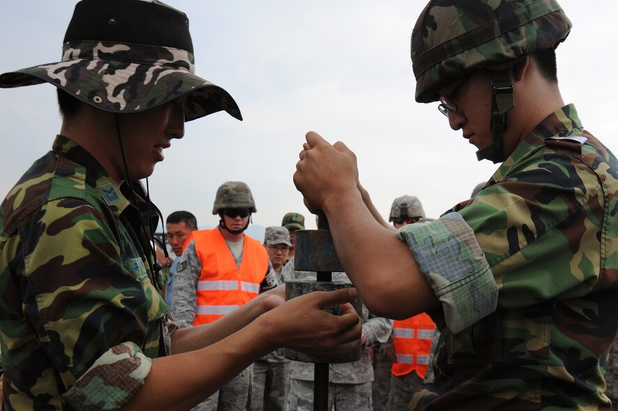 TAEGU AIR BASE, Republic of Korea -- Republic of Korea Air Force Airmen from the 11th Civil Engineer Squadron perform a compaction test during the 2011 Combined Airfield Damage Repair Exercise here Sept. 8. The purpose of the exercise was to enhance interoperability, evaluate capabilities and strengthen combined relationships between U.S. and ROKAF members. (U.S. Air Force photo/Senior Airman Brittany Y. Bateman)